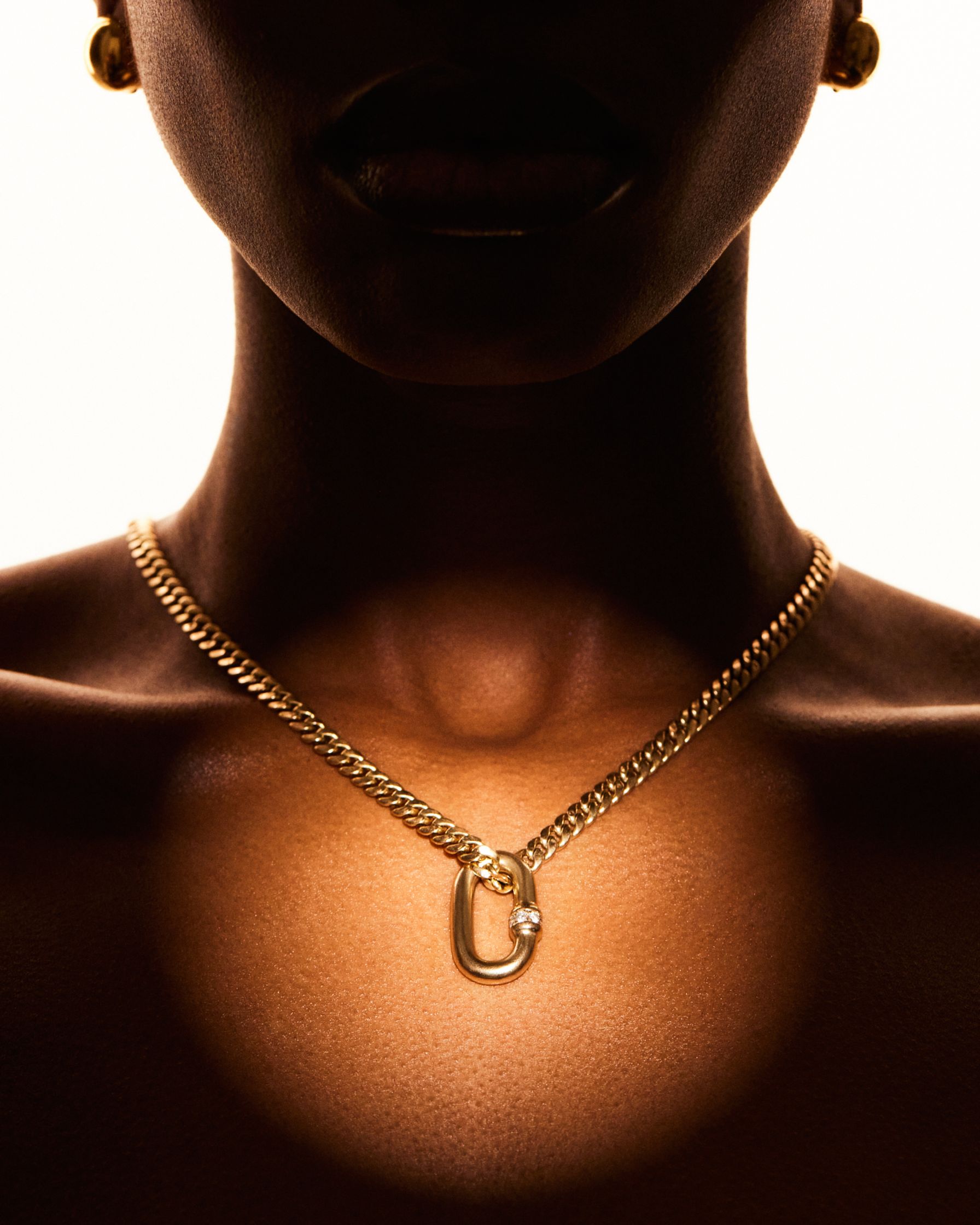 an image of a woman wearing a gold necklace