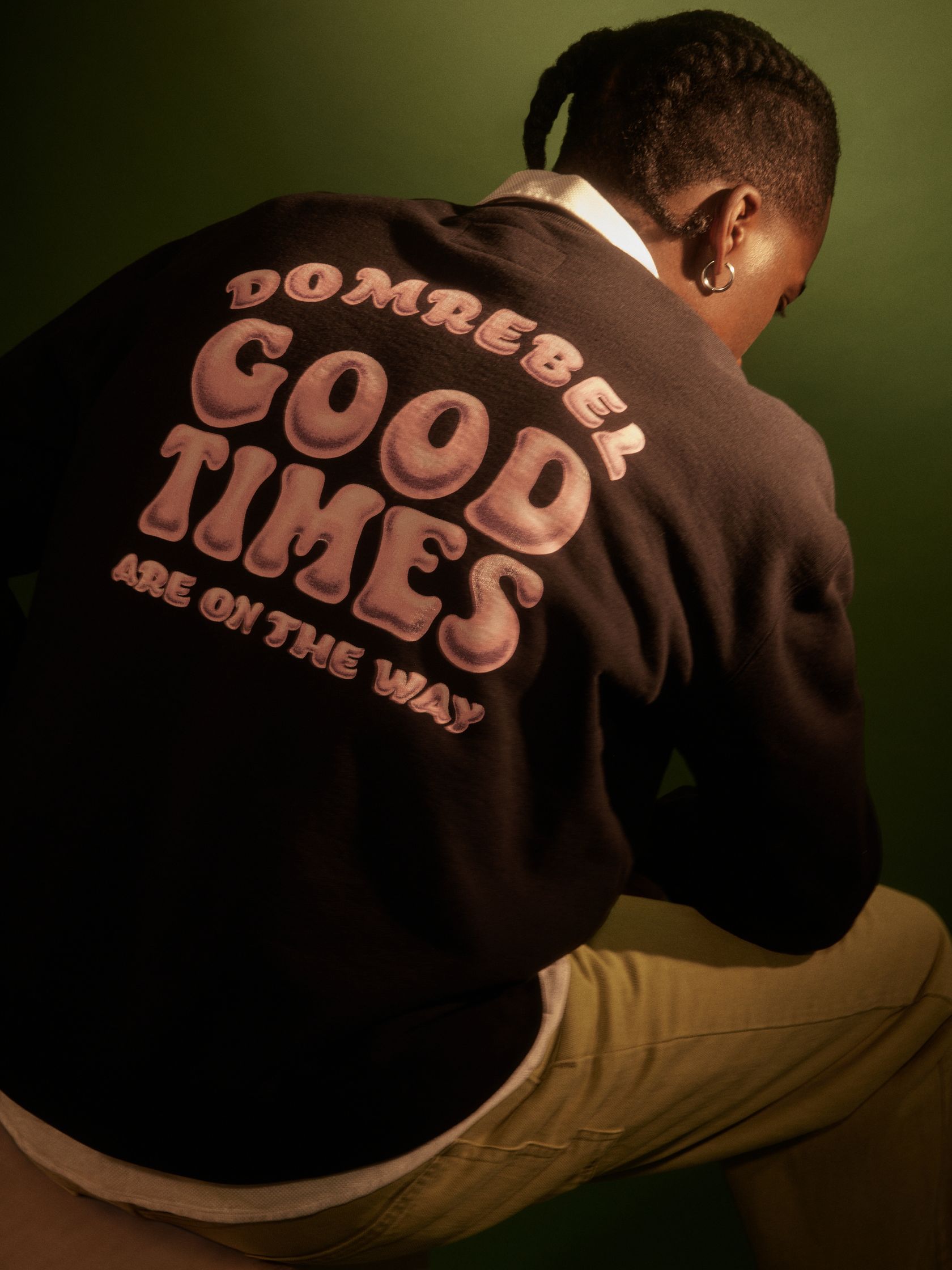 a man wearing a sweatshirt that says good times are on the way