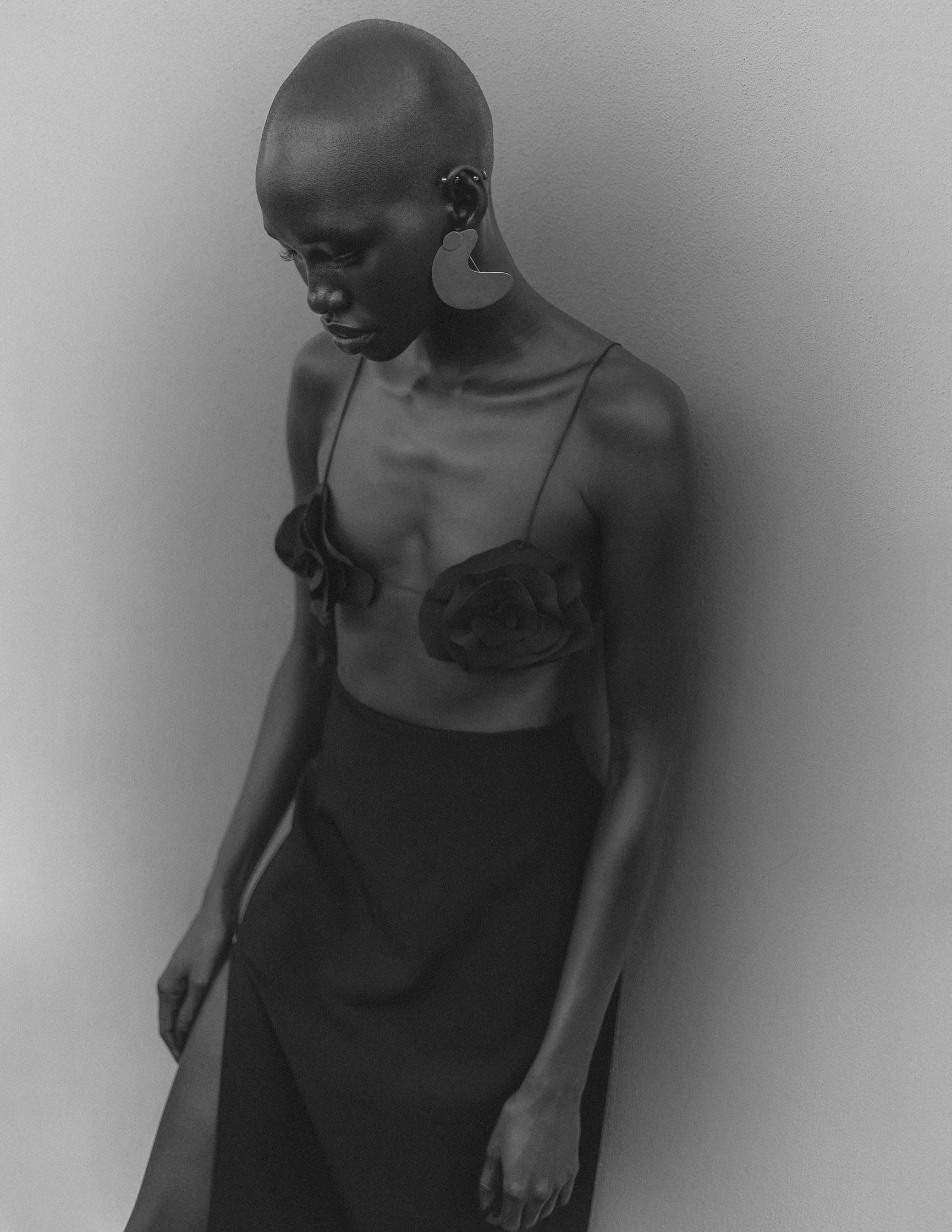 a black and white photo of a woman with a shaved head