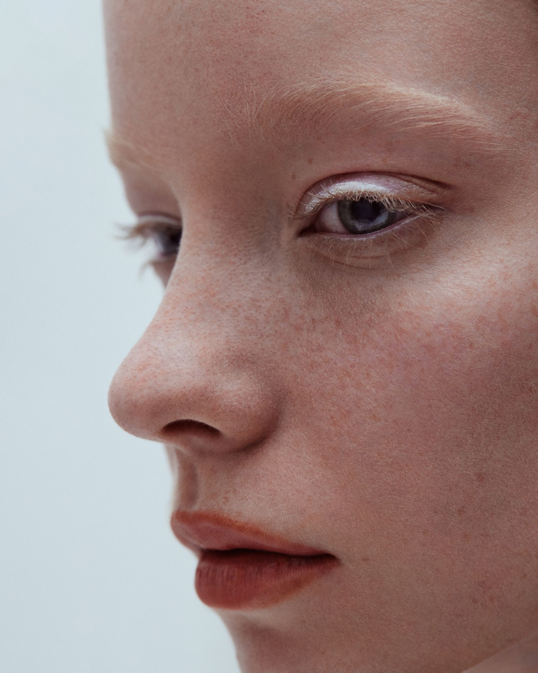 a close up of a woman with freckles on her face