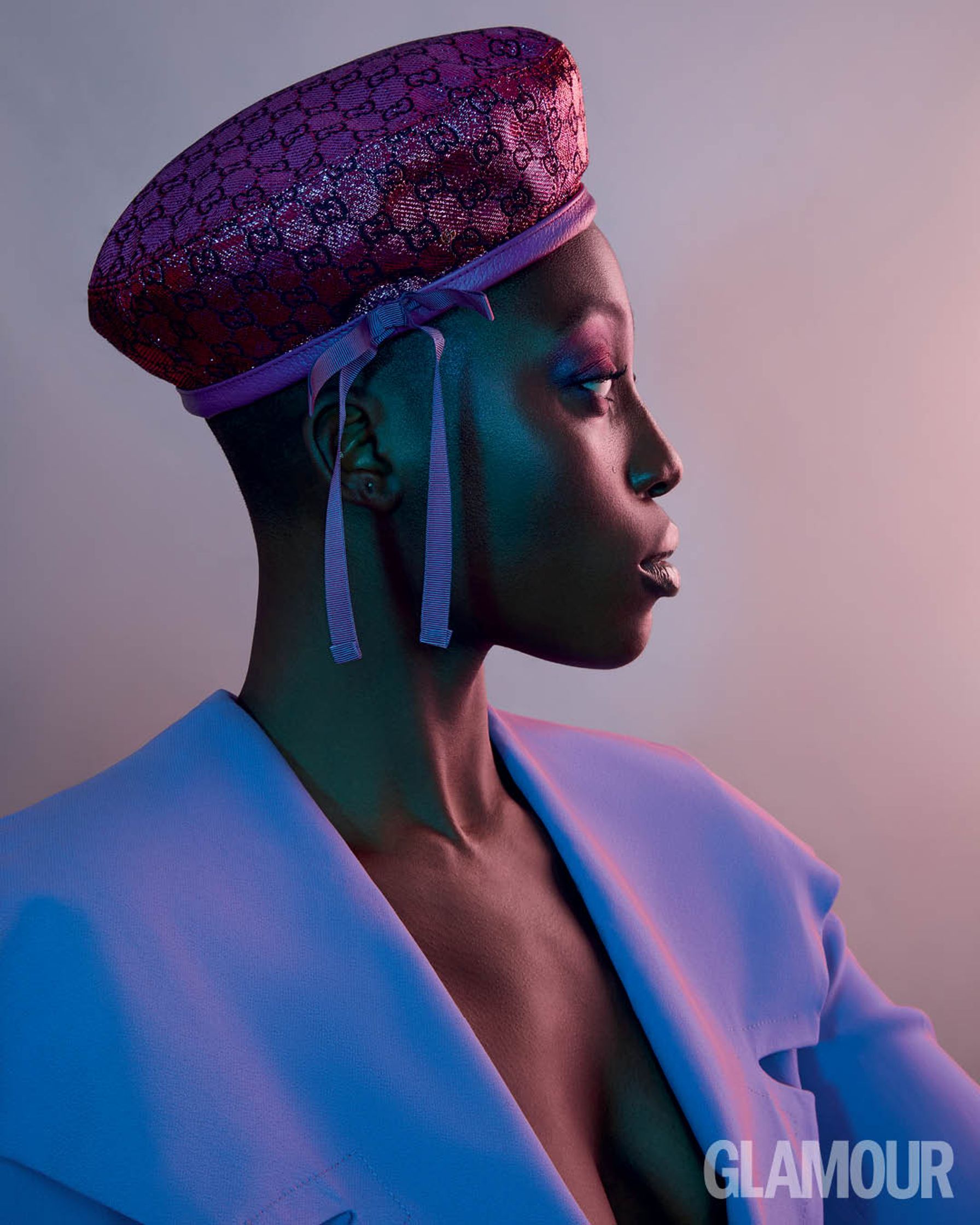 a black woman wearing a purple hat
