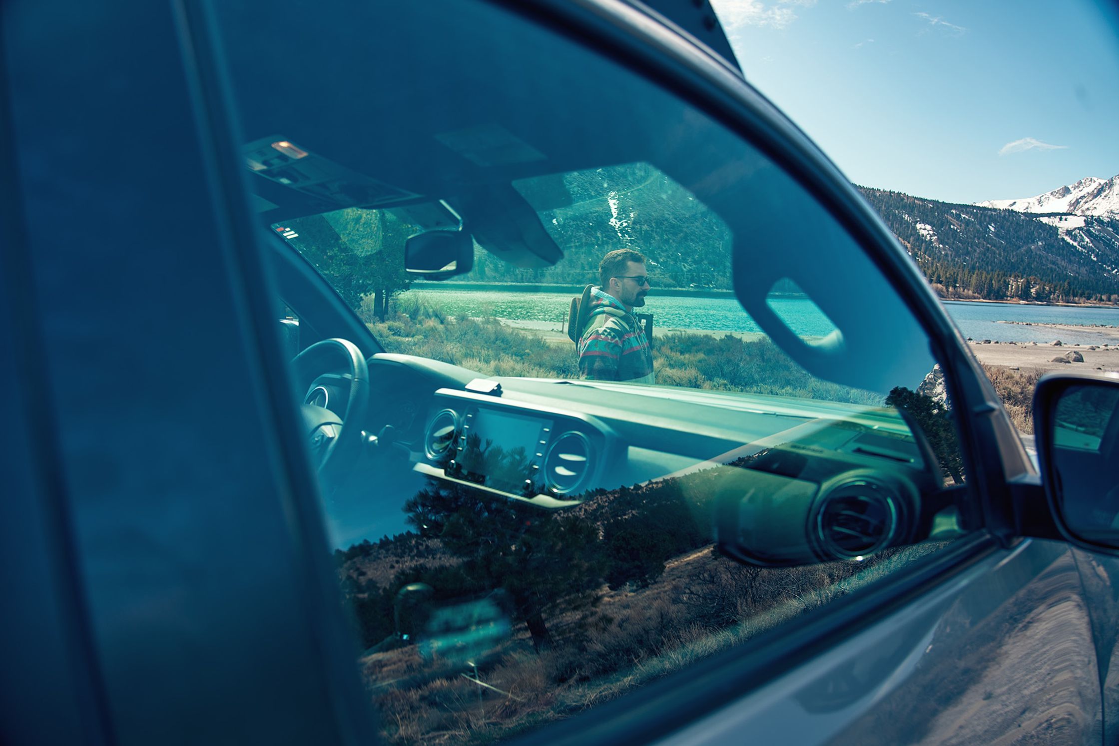 a reflection of a person in a car window