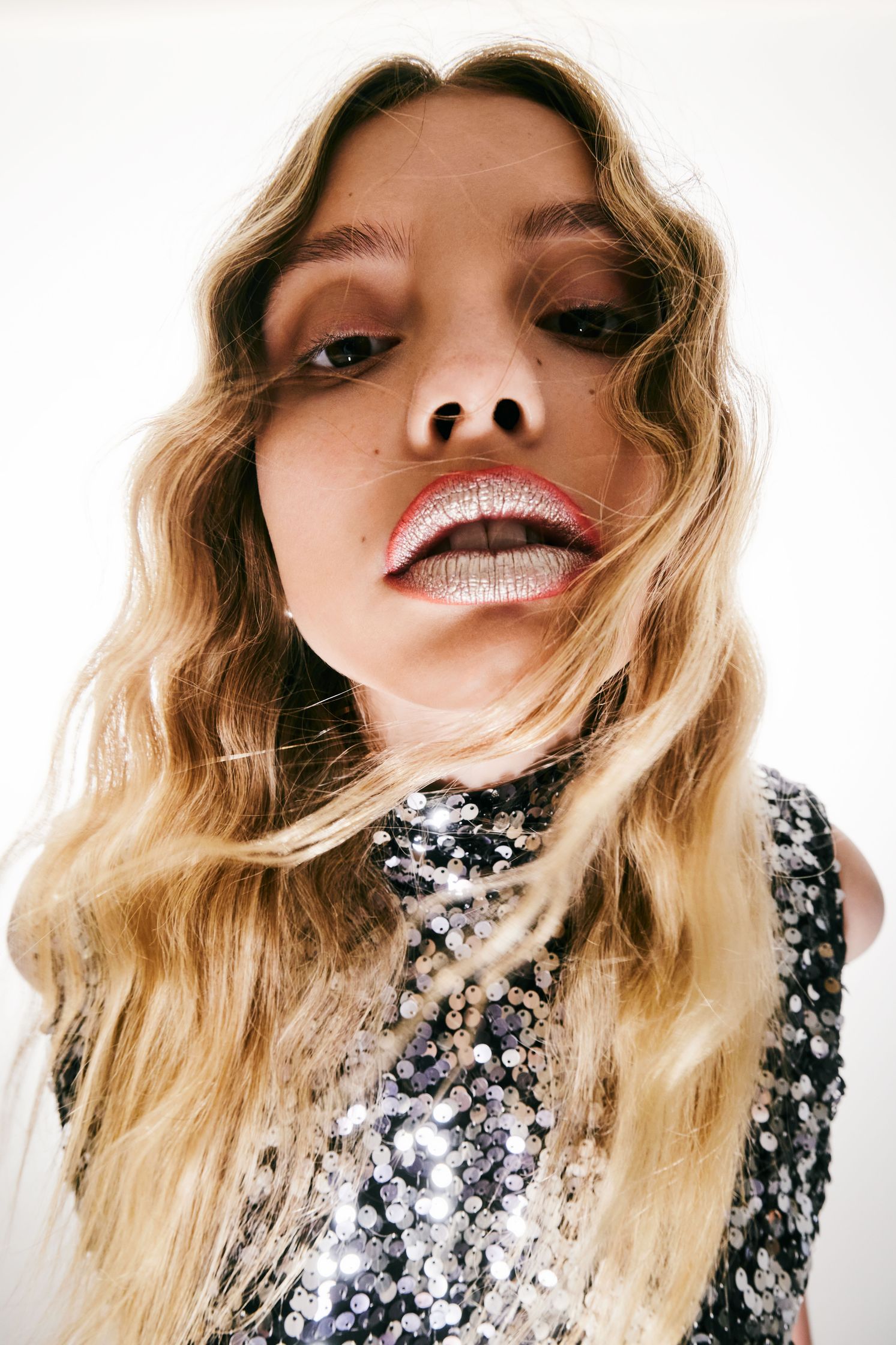 a woman in a sequin dress is posing for a photo