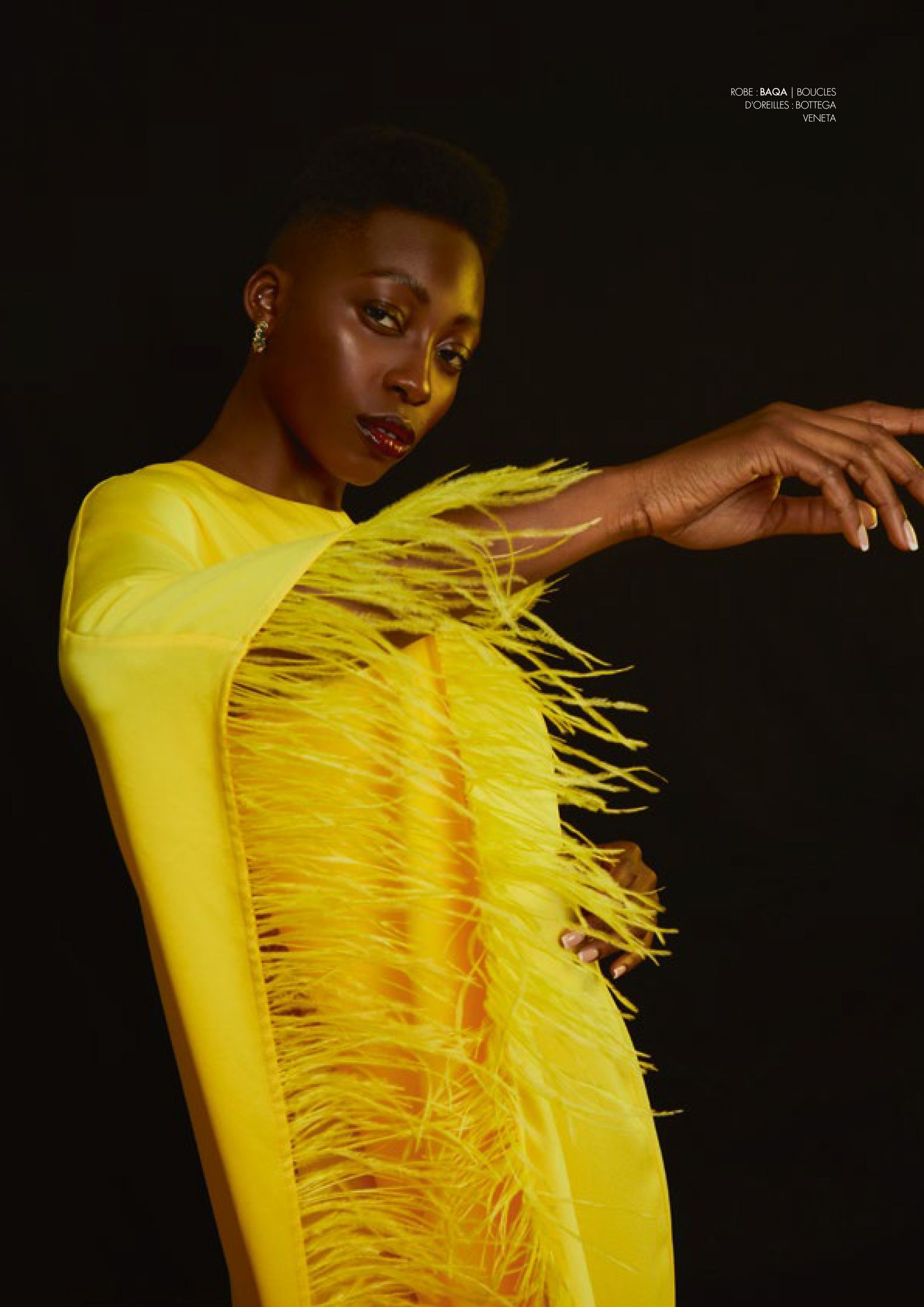 a woman in a yellow dress posing for a magazine