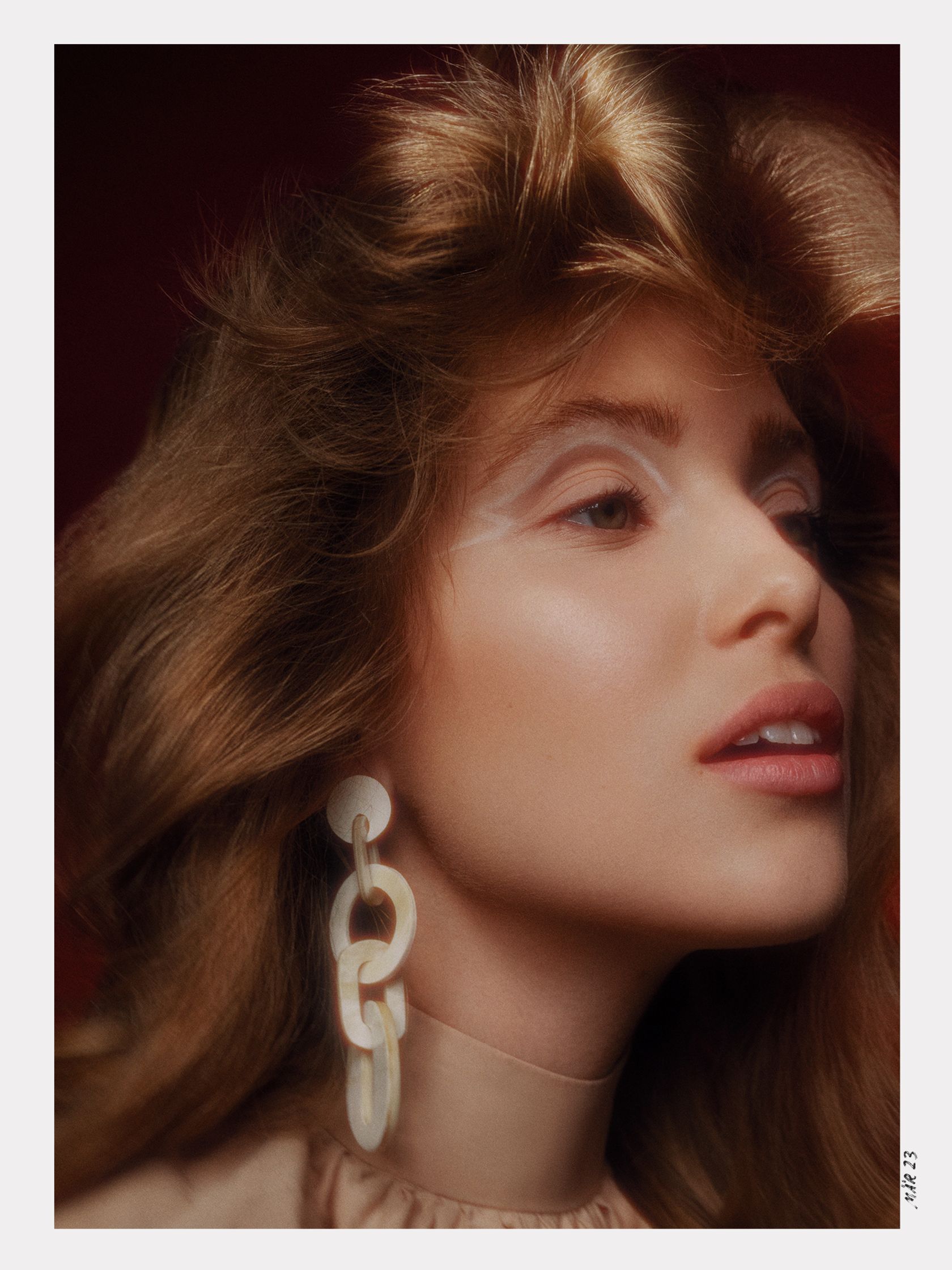 an image of a woman with long hair and earrings