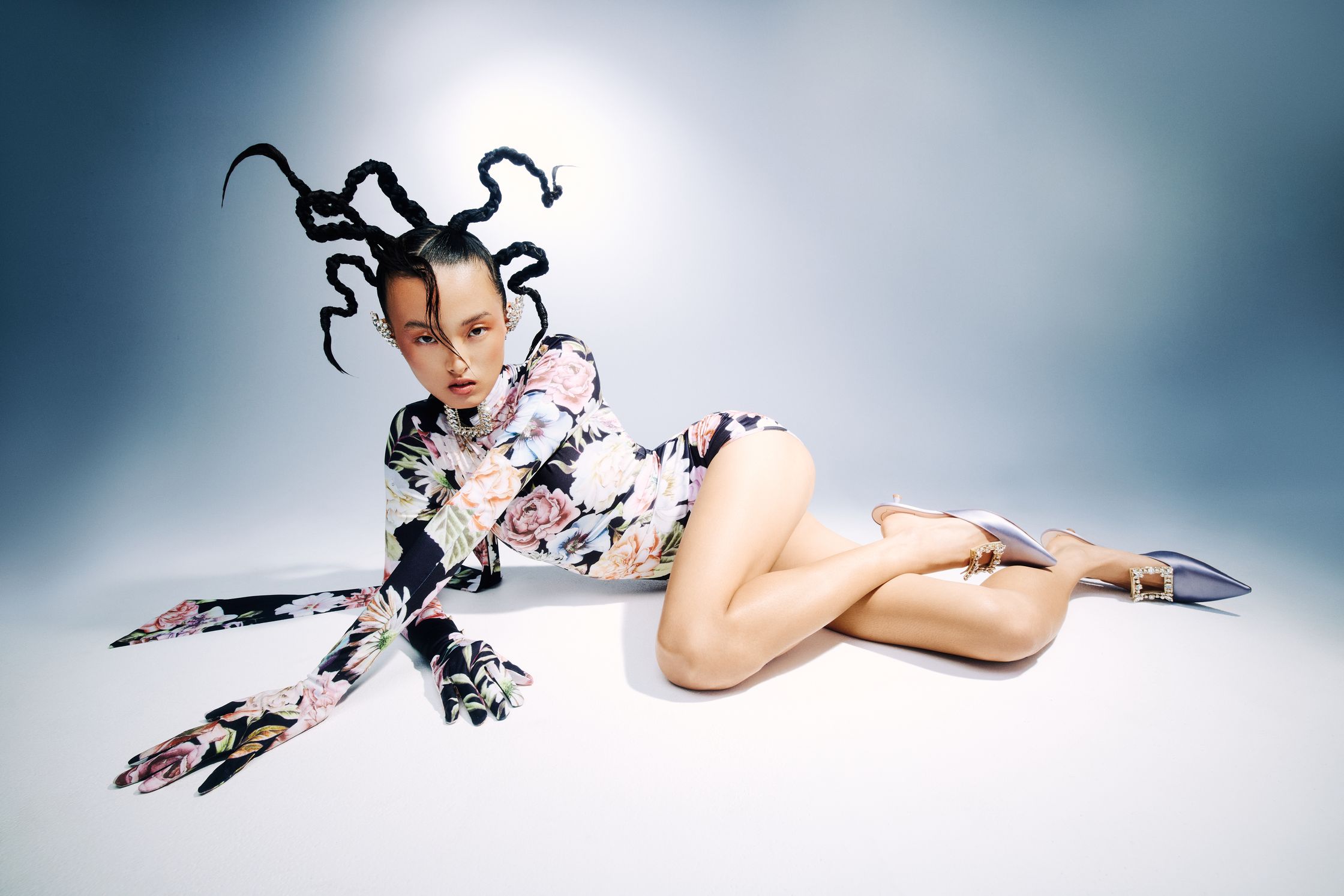 a woman in a floral dress laying on the floor
