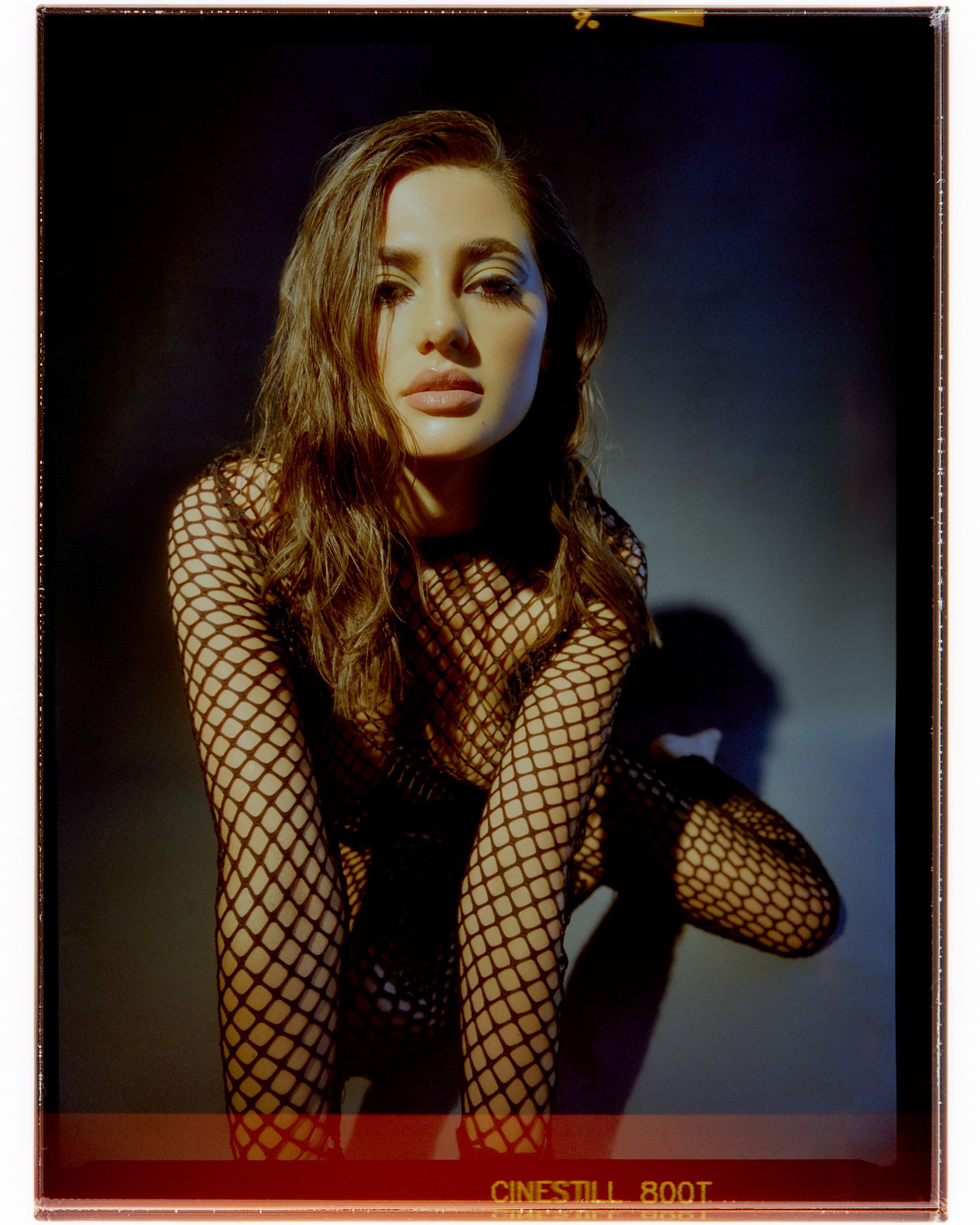 a woman in fishnets posing for a photo