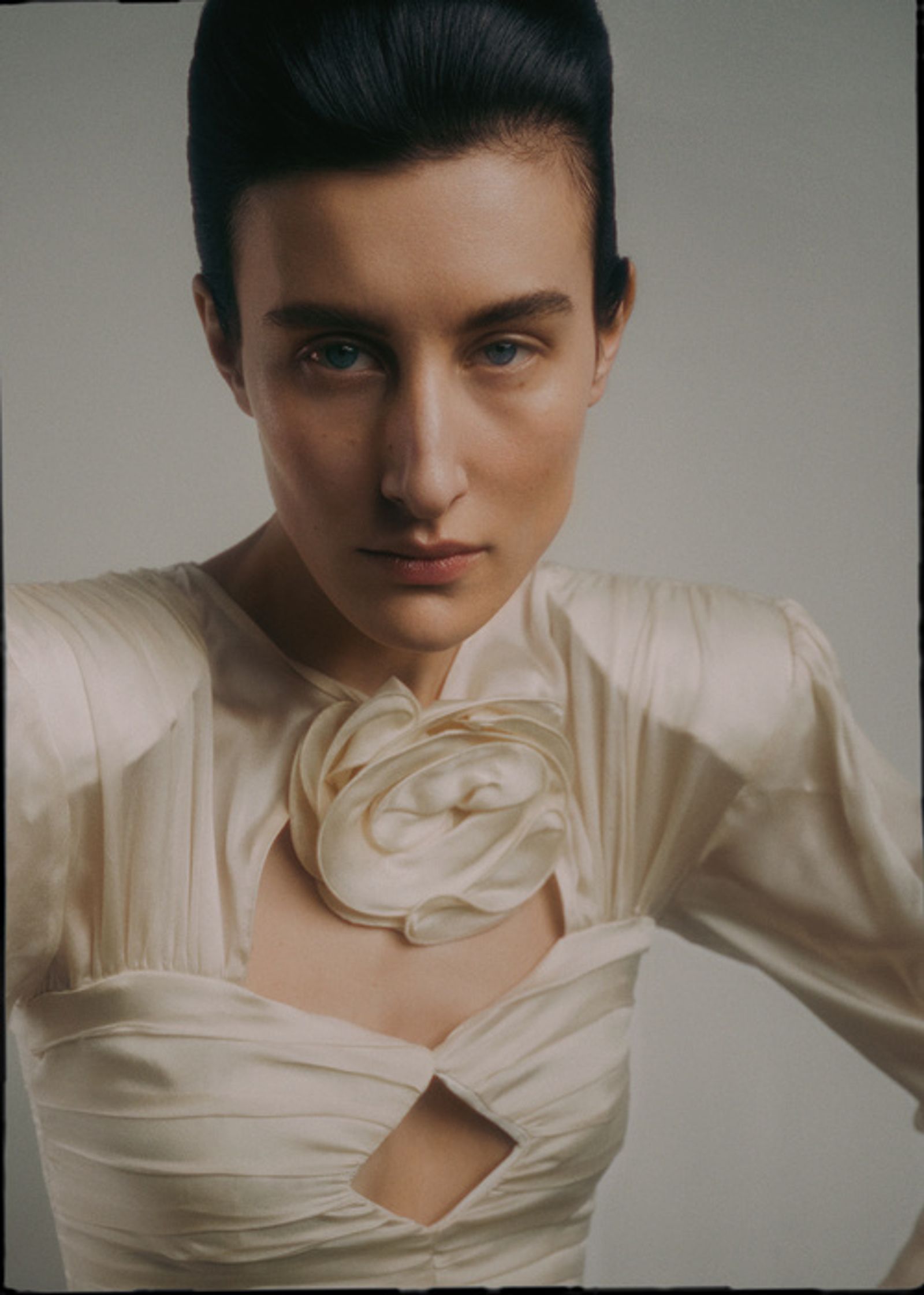a woman in a white dress posing for a photo