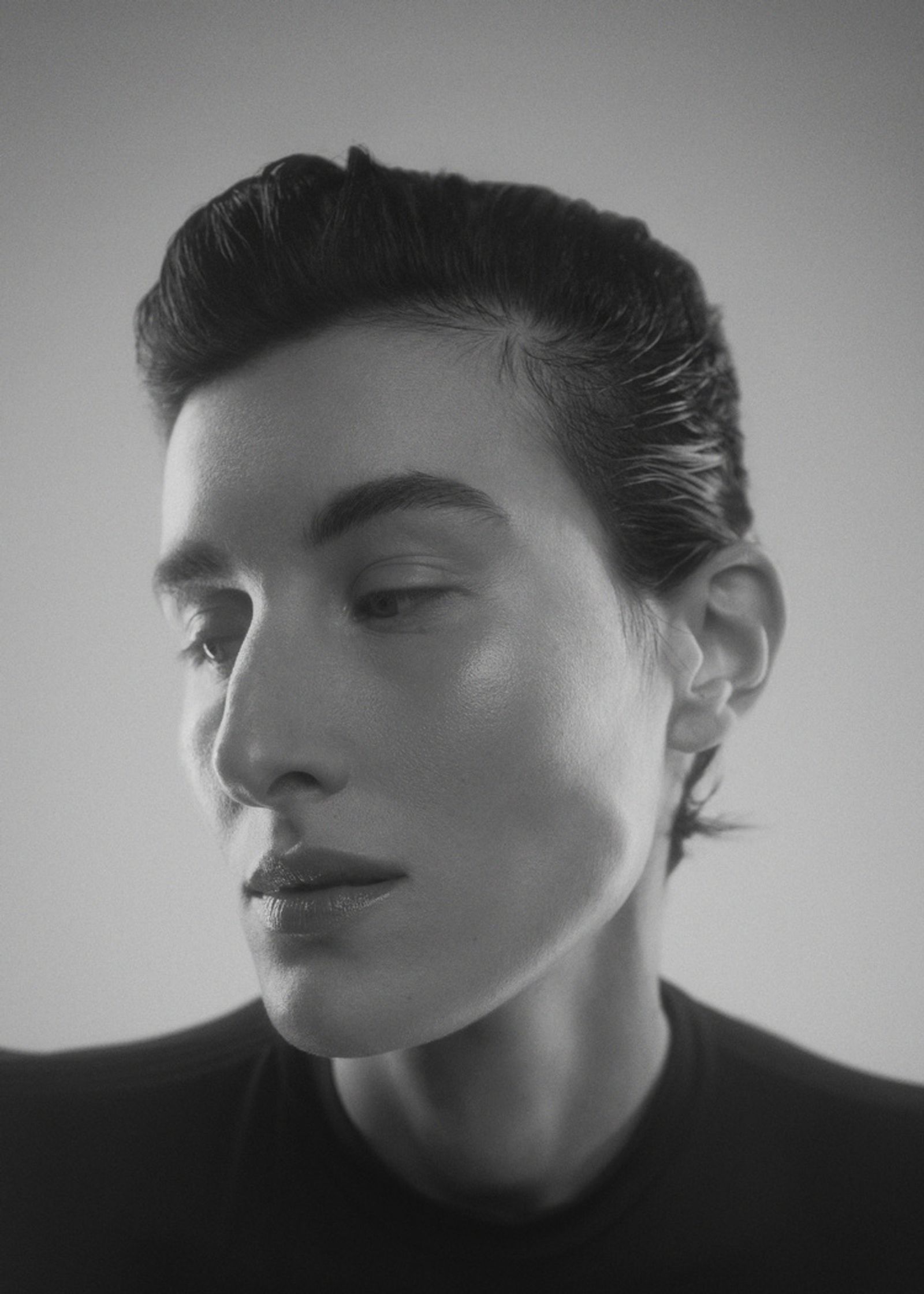 a black and white photo of a woman with short hair