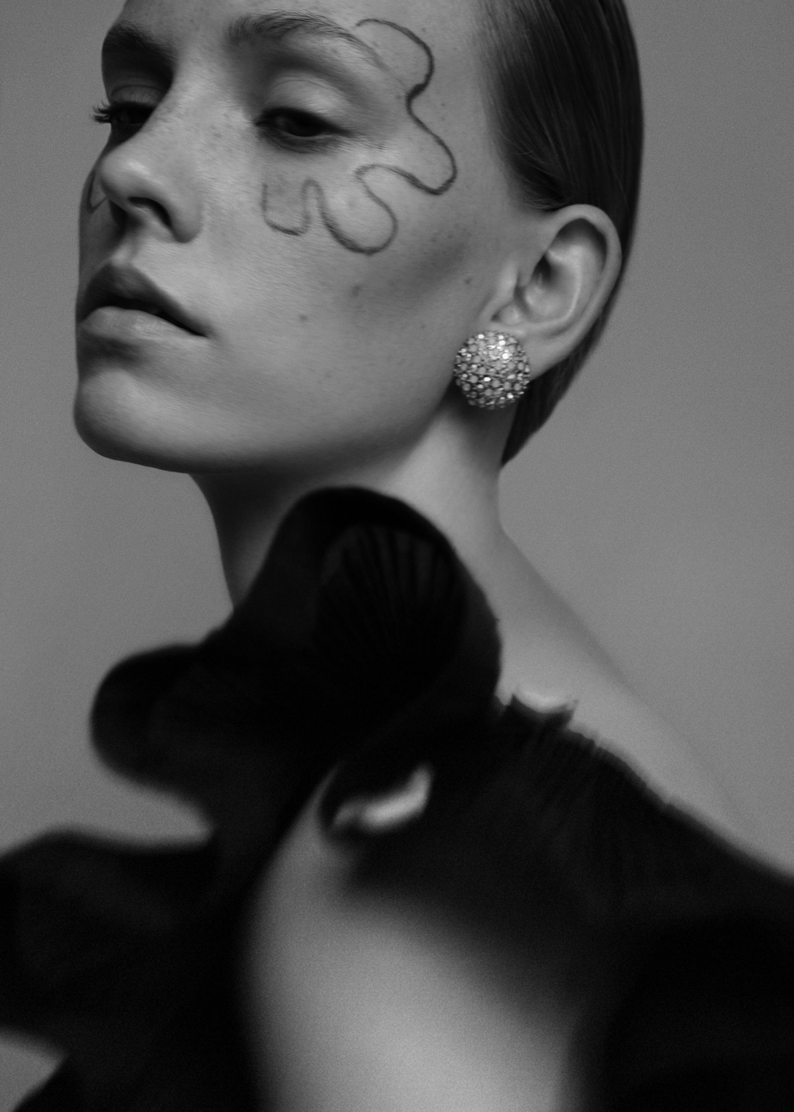 a black and white photo of a woman with makeup on her face