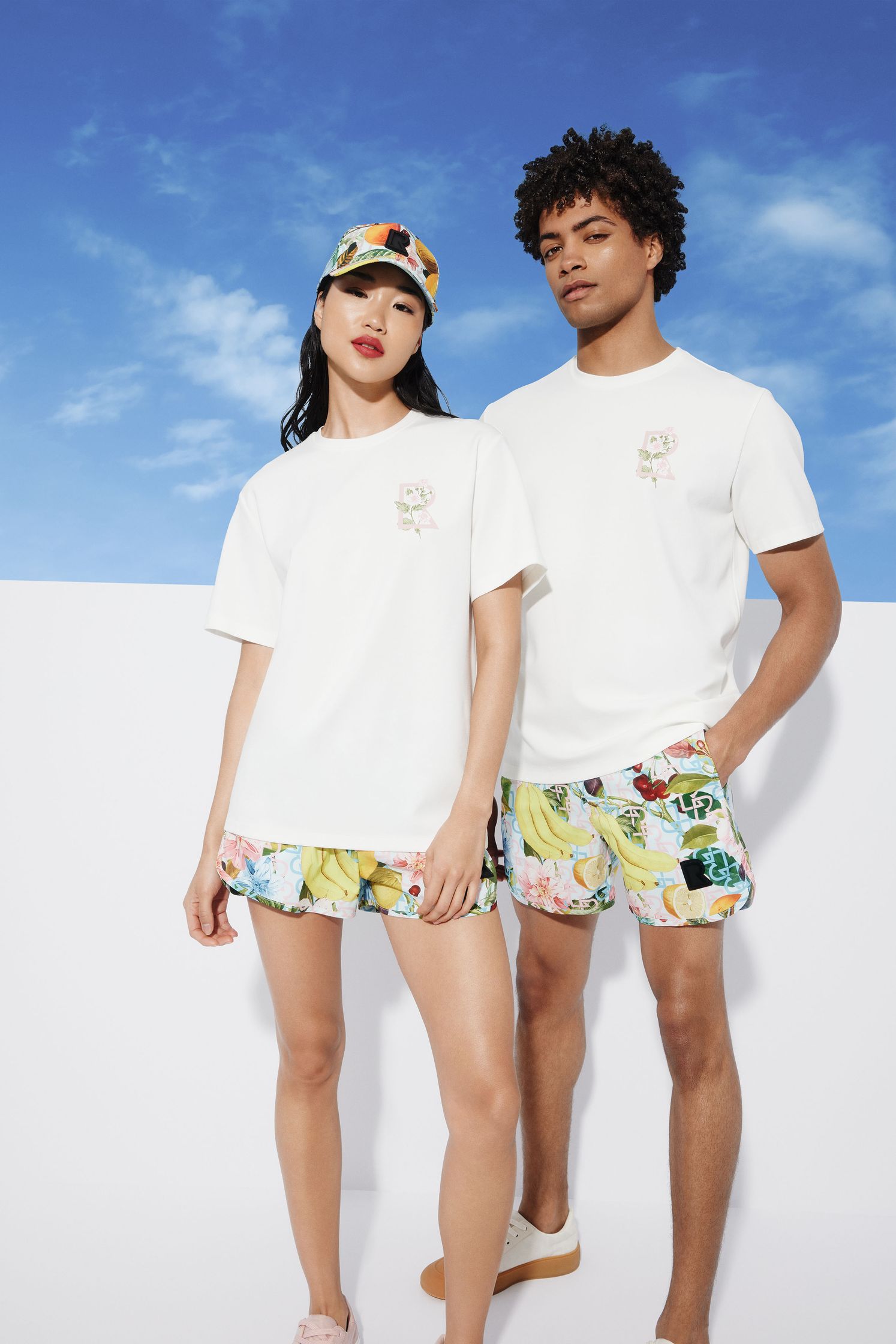 a man and a woman wearing t - shirts and shorts