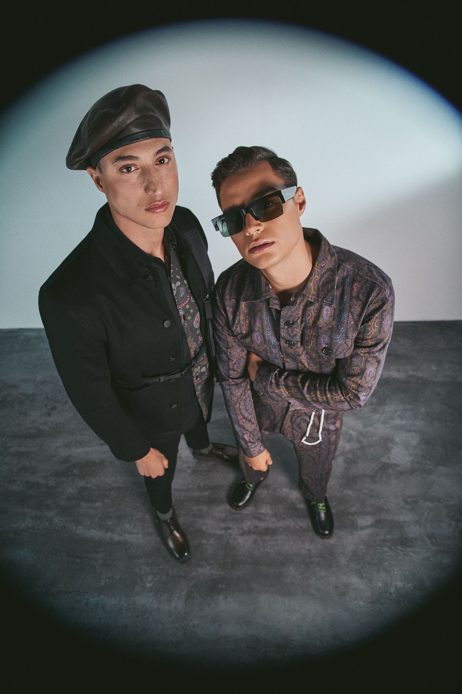 two men in sunglasses standing next to each other