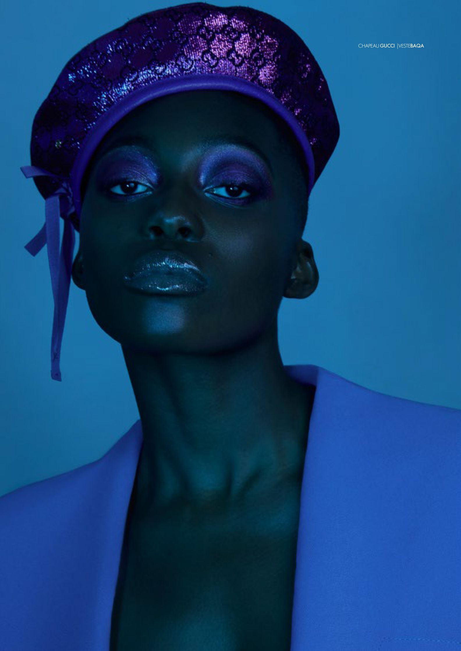 a black woman wearing a purple hat