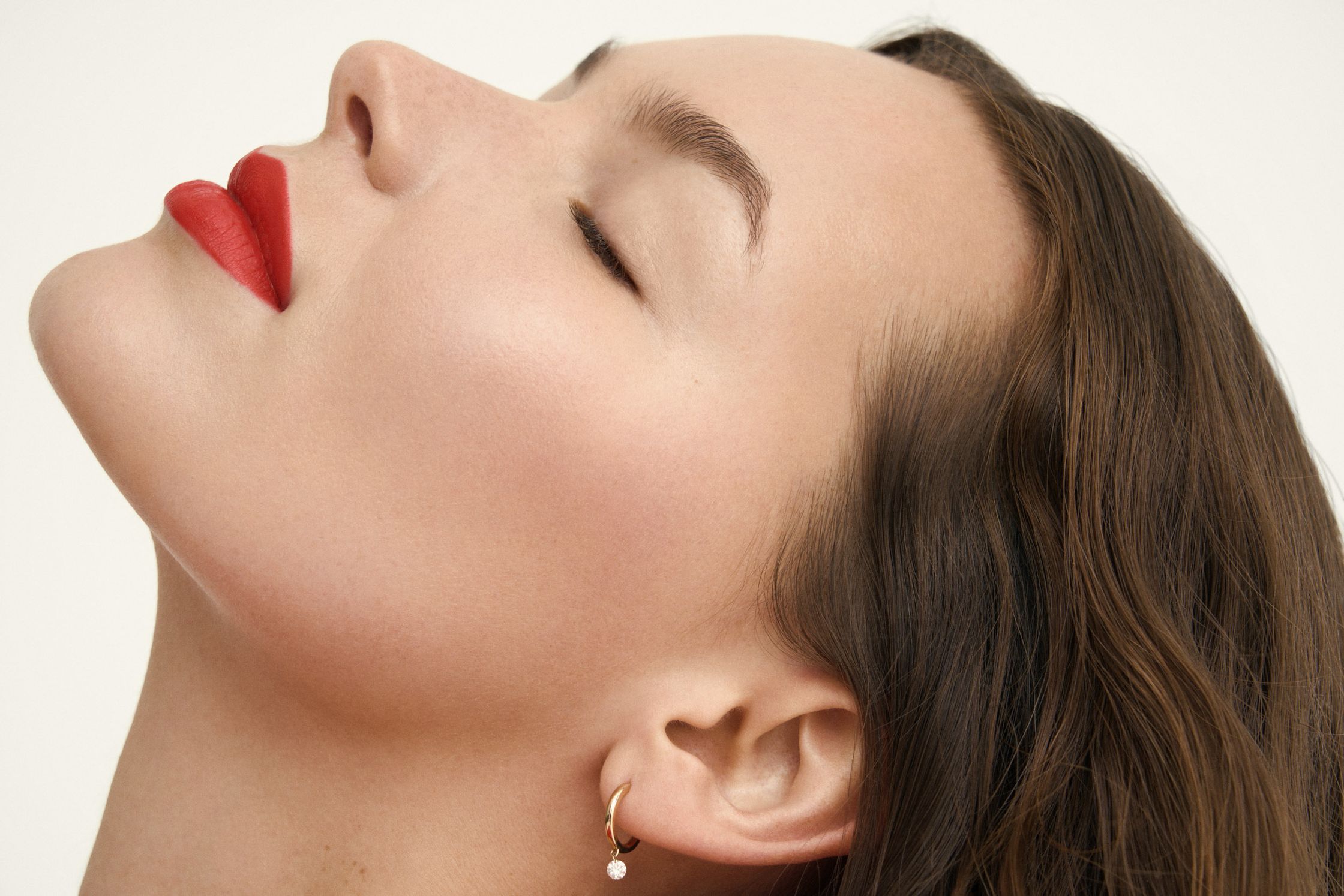 a woman with red lips looking up at the sky