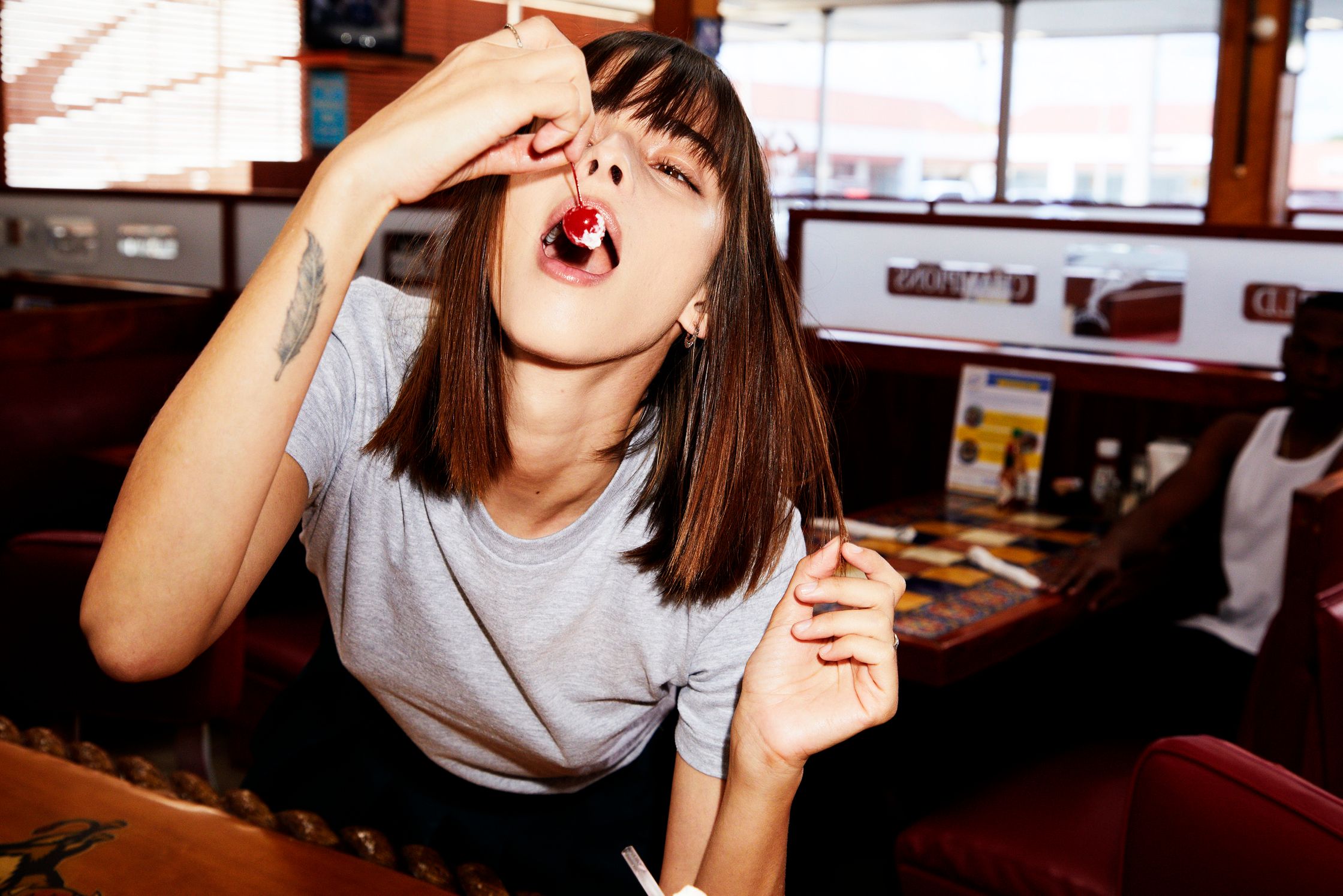 a woman is sitting at a table in a restaurant