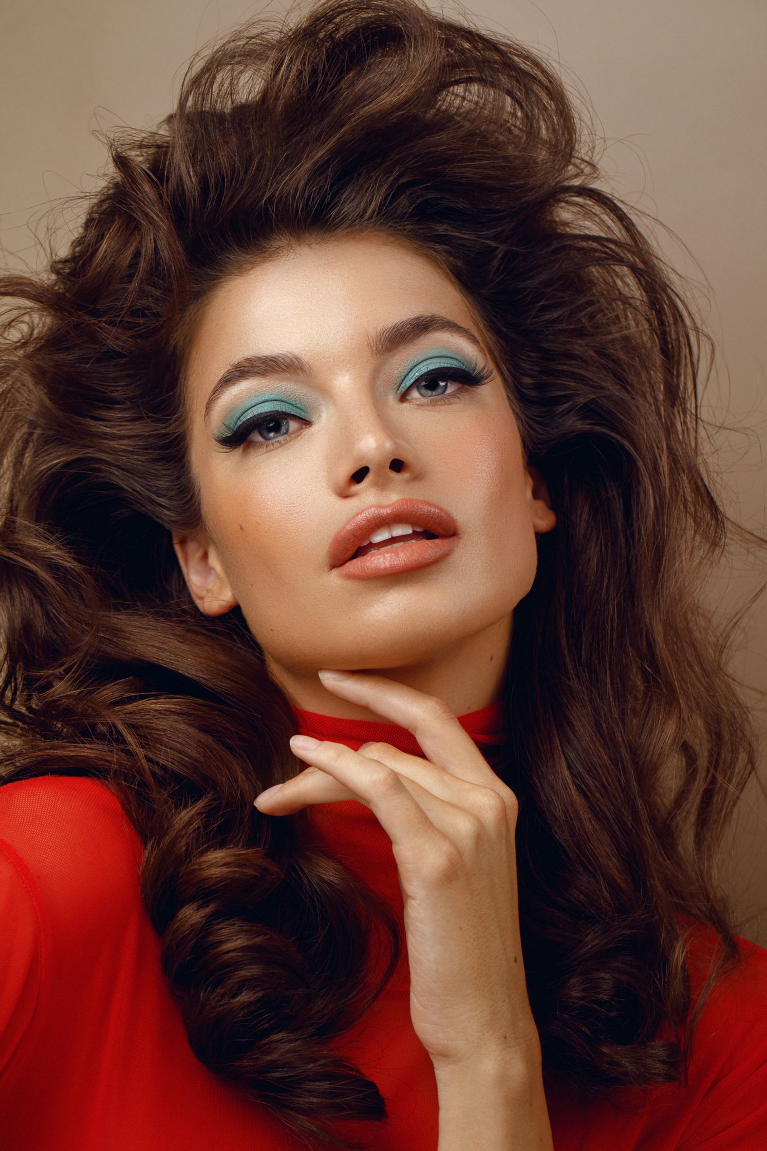 a beautiful woman with long hair and blue eye makeup