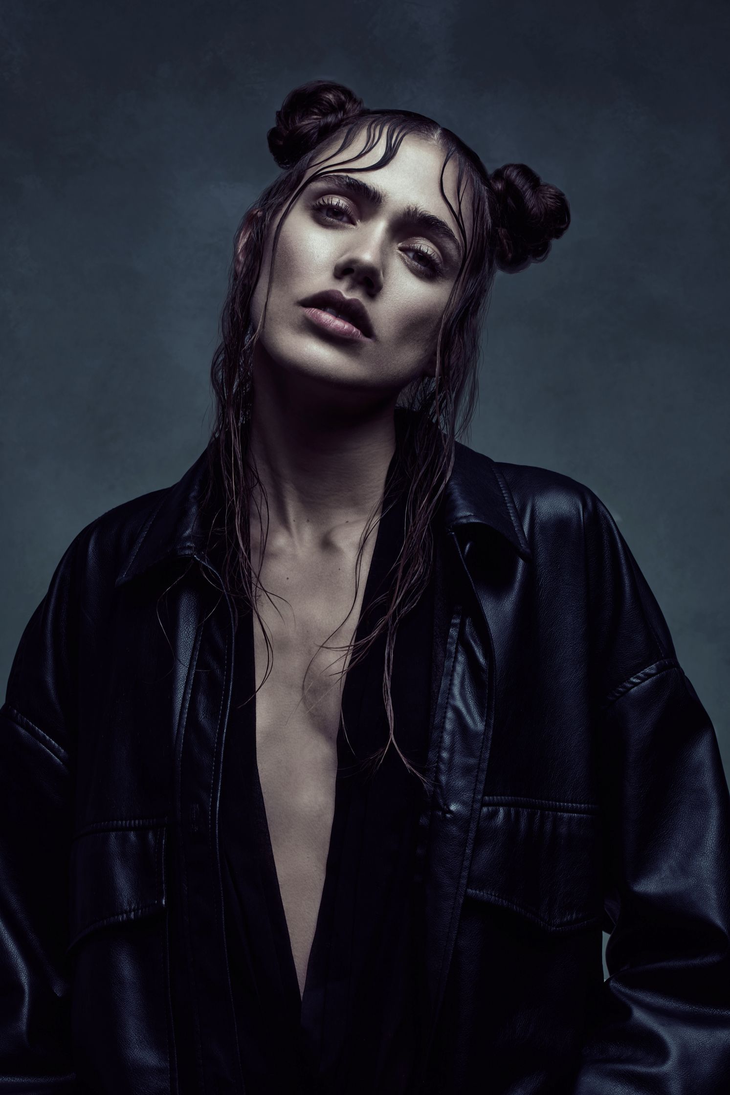 Close-up of model Ilona Gachet with wet, styled hair and a dark, minimalist aesthetic reminiscent of The Matrix