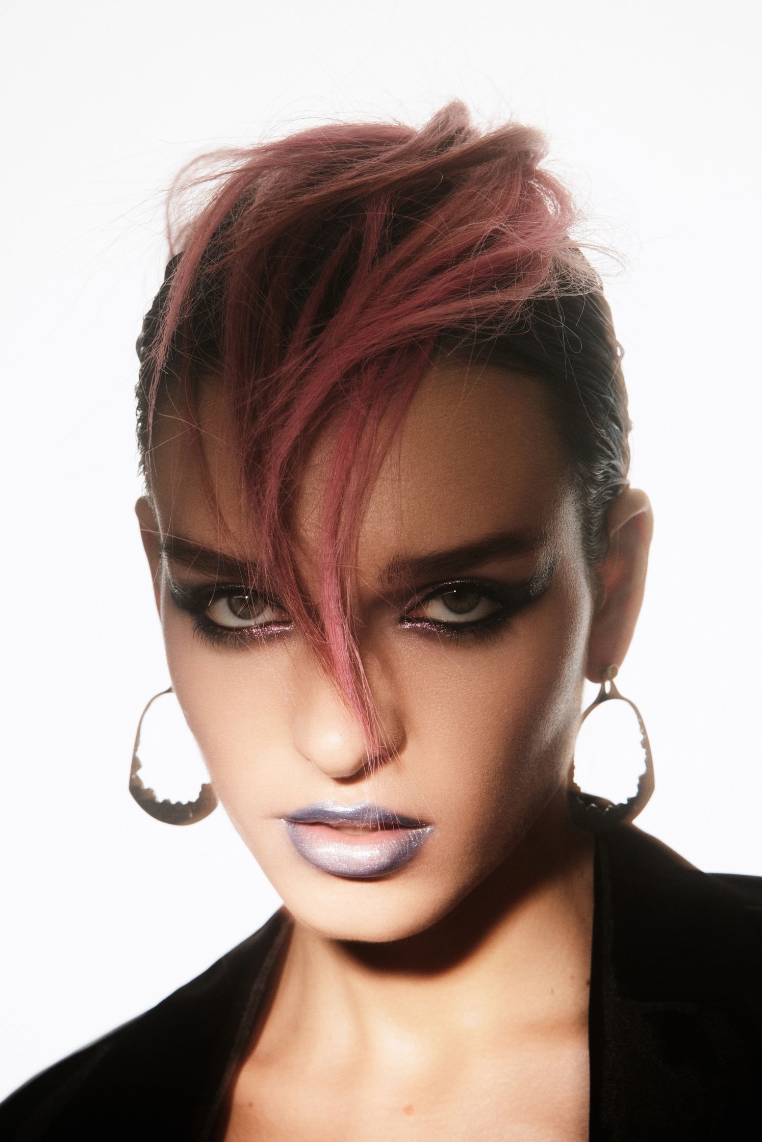 a woman with pink hair is posing for a photo