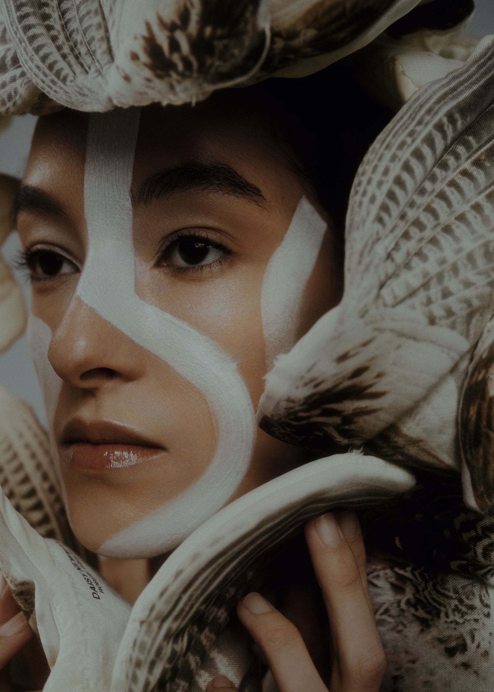 a woman with a face covered in white feathers