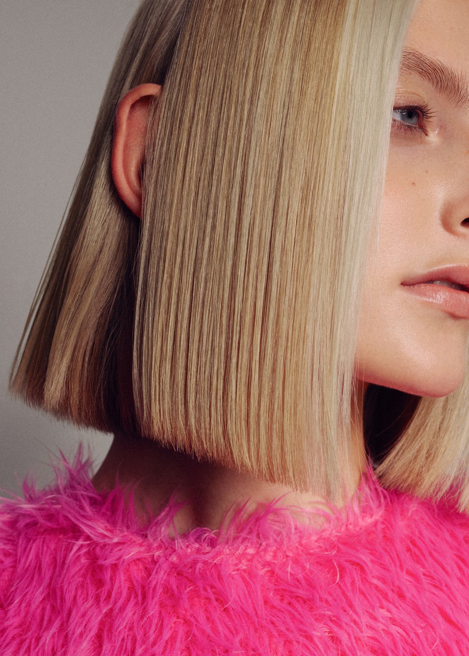 a blonde woman wearing a pink furry sweater