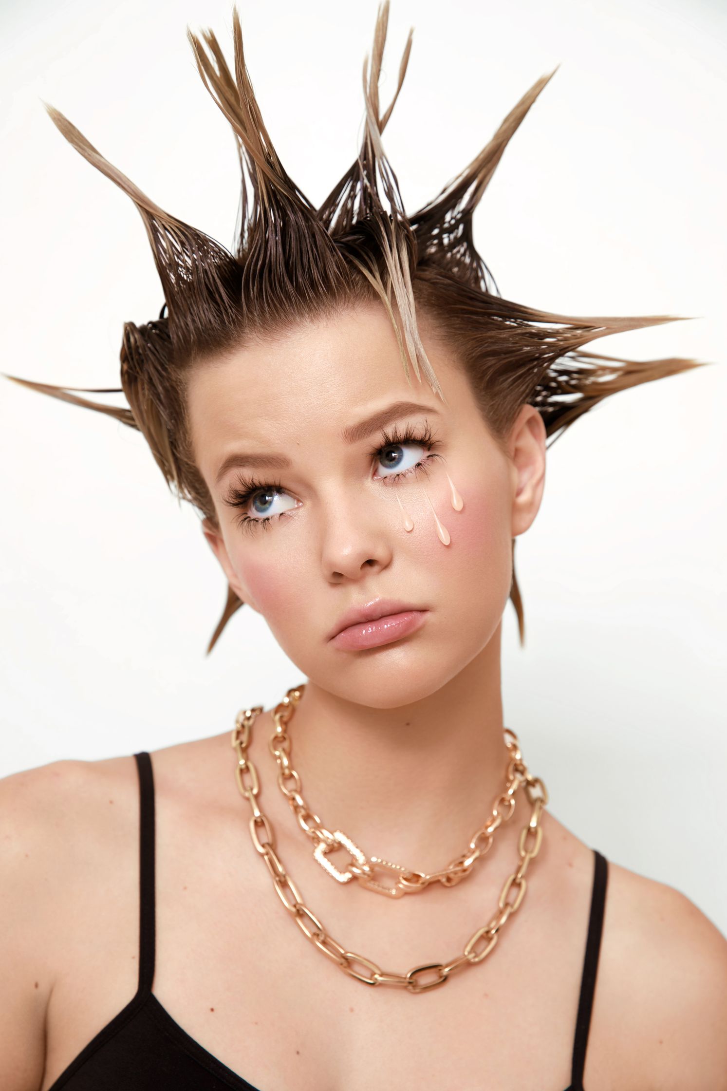 a woman with spiked hair on her head