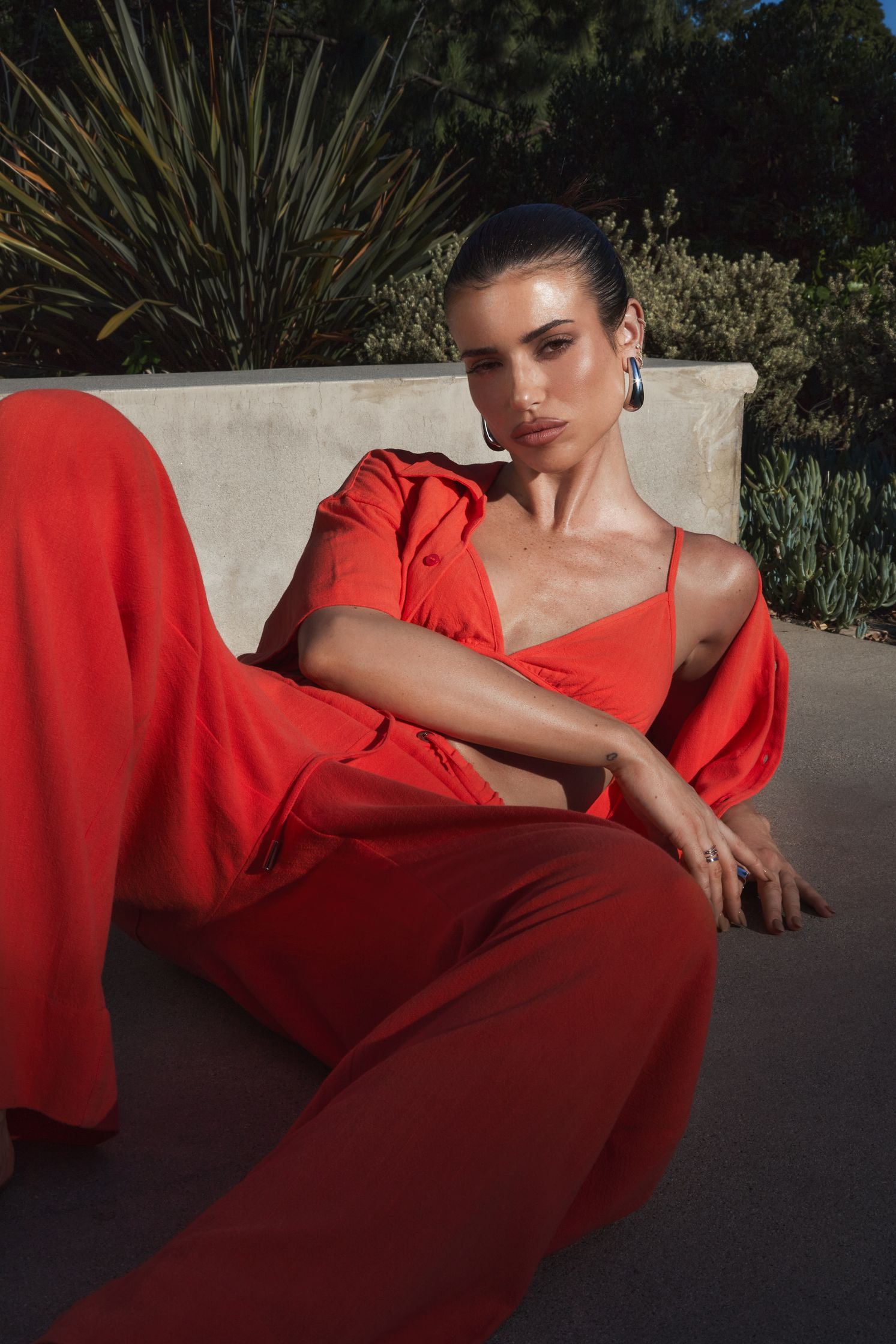 a woman in an orange jumpsuit laying on the ground