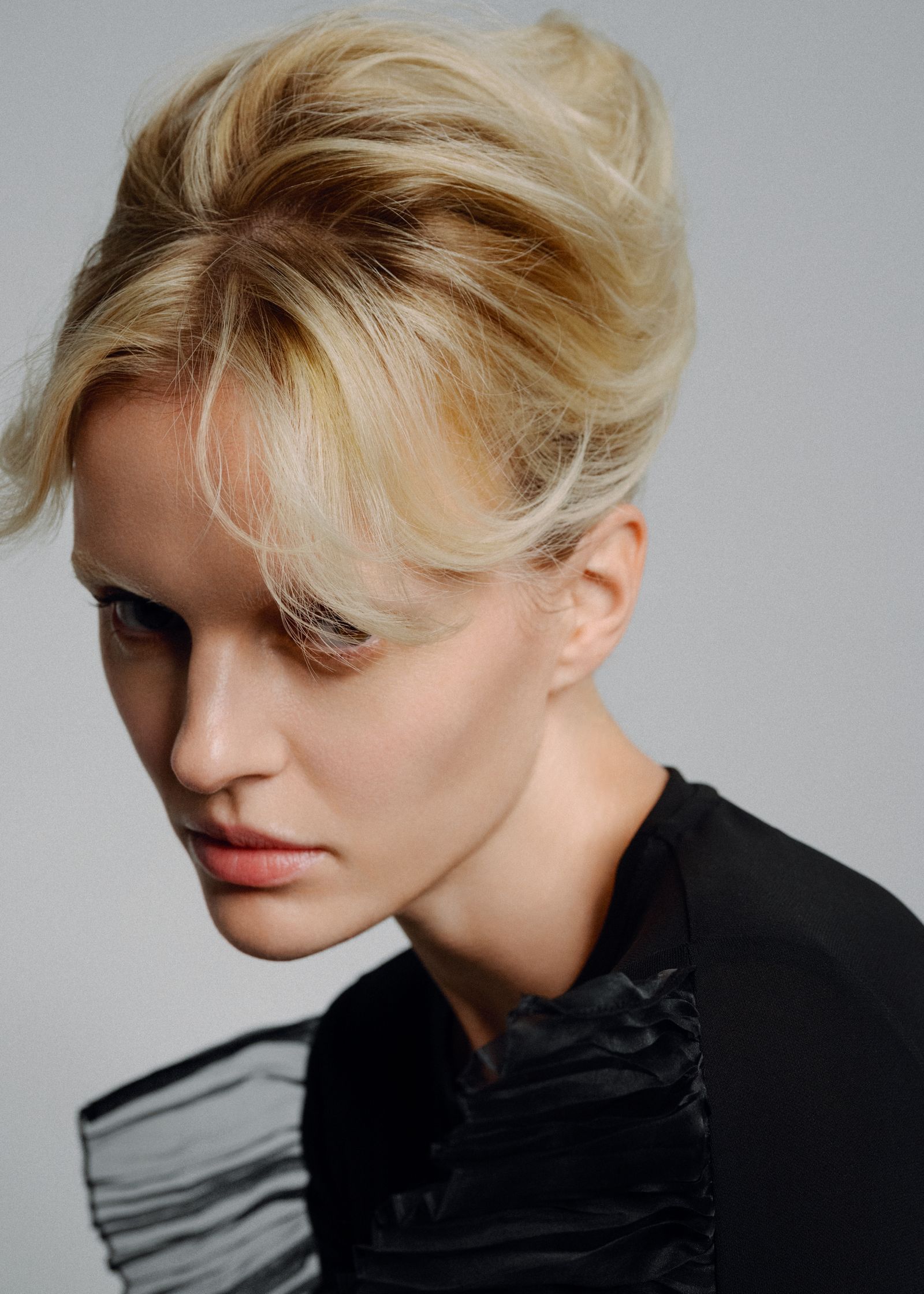 a woman with blonde hair in a black top