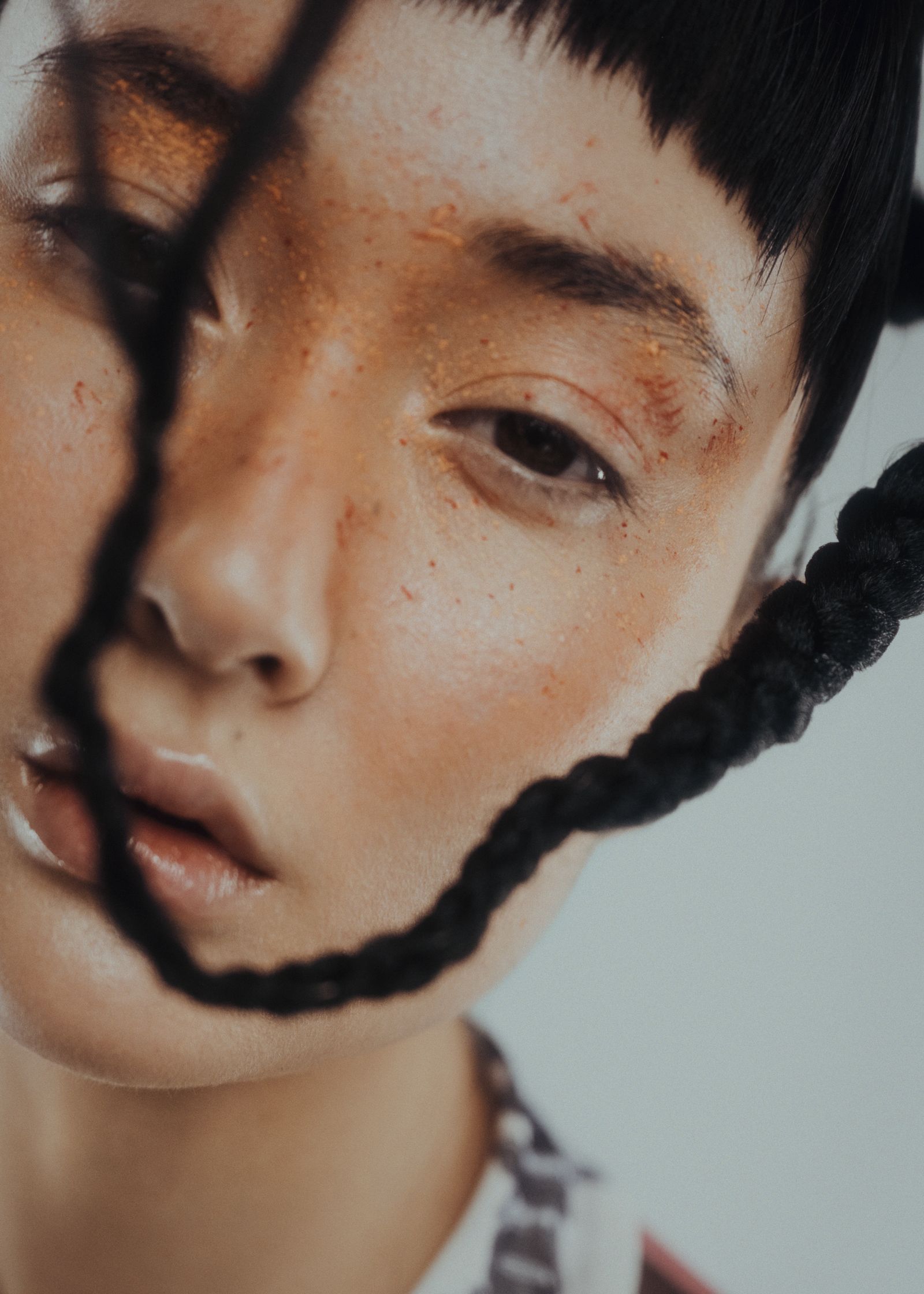 a woman with braided hair is looking at the camera