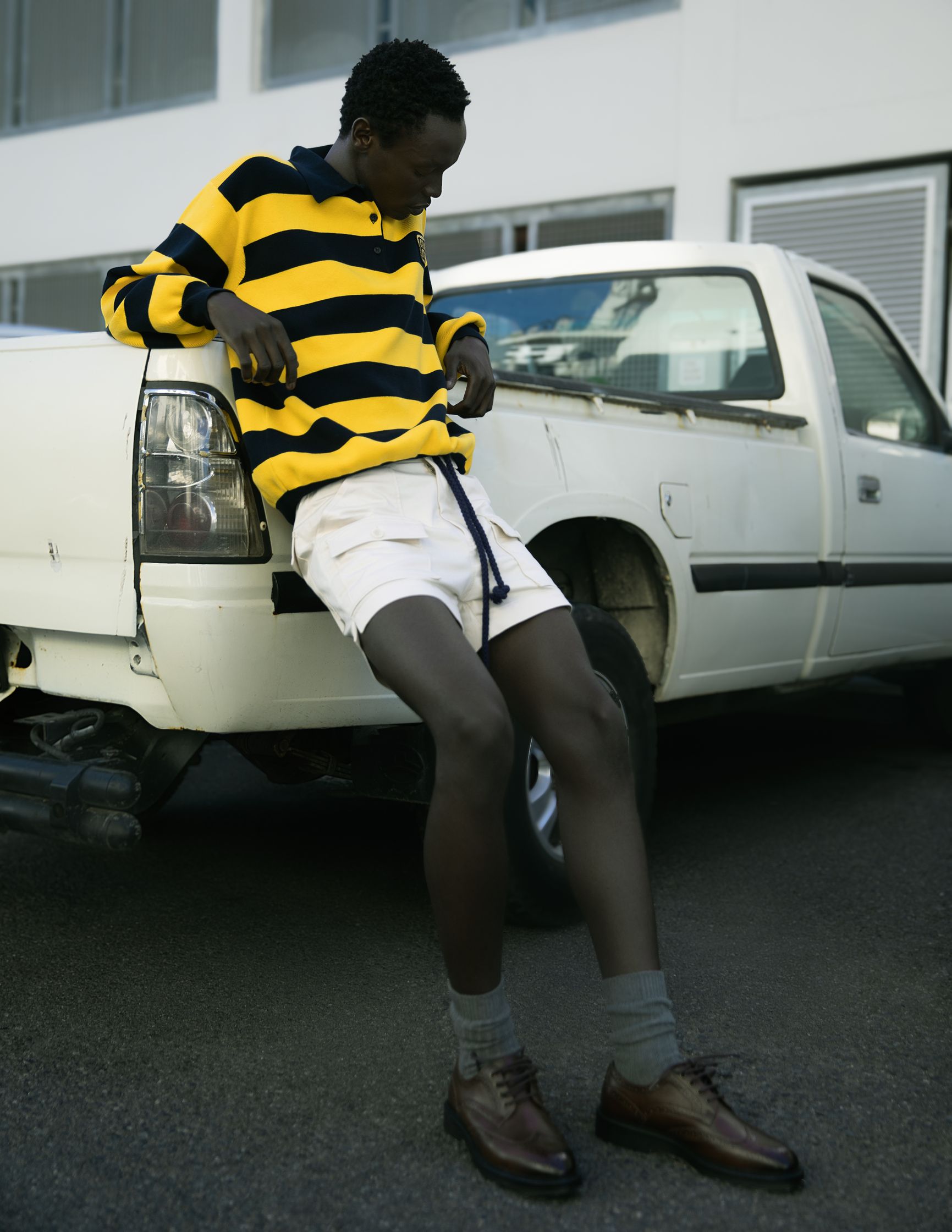 a man sitting on the hood of a white truck