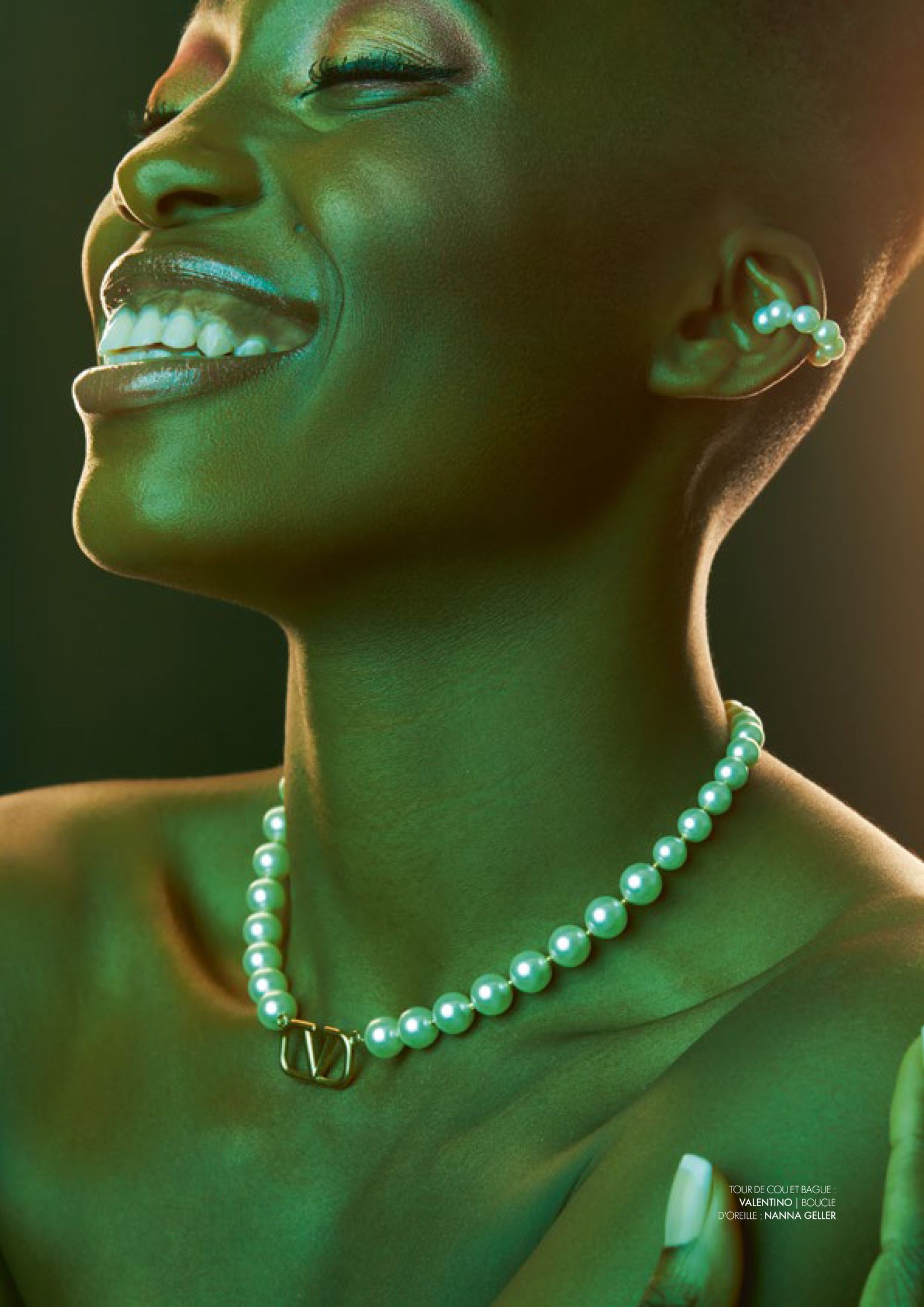 a woman with pearls and a smile on her face