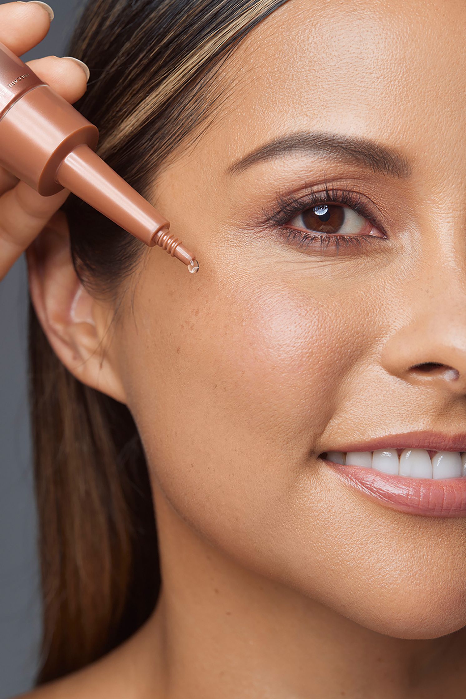 a woman is applying a bronzer to her face