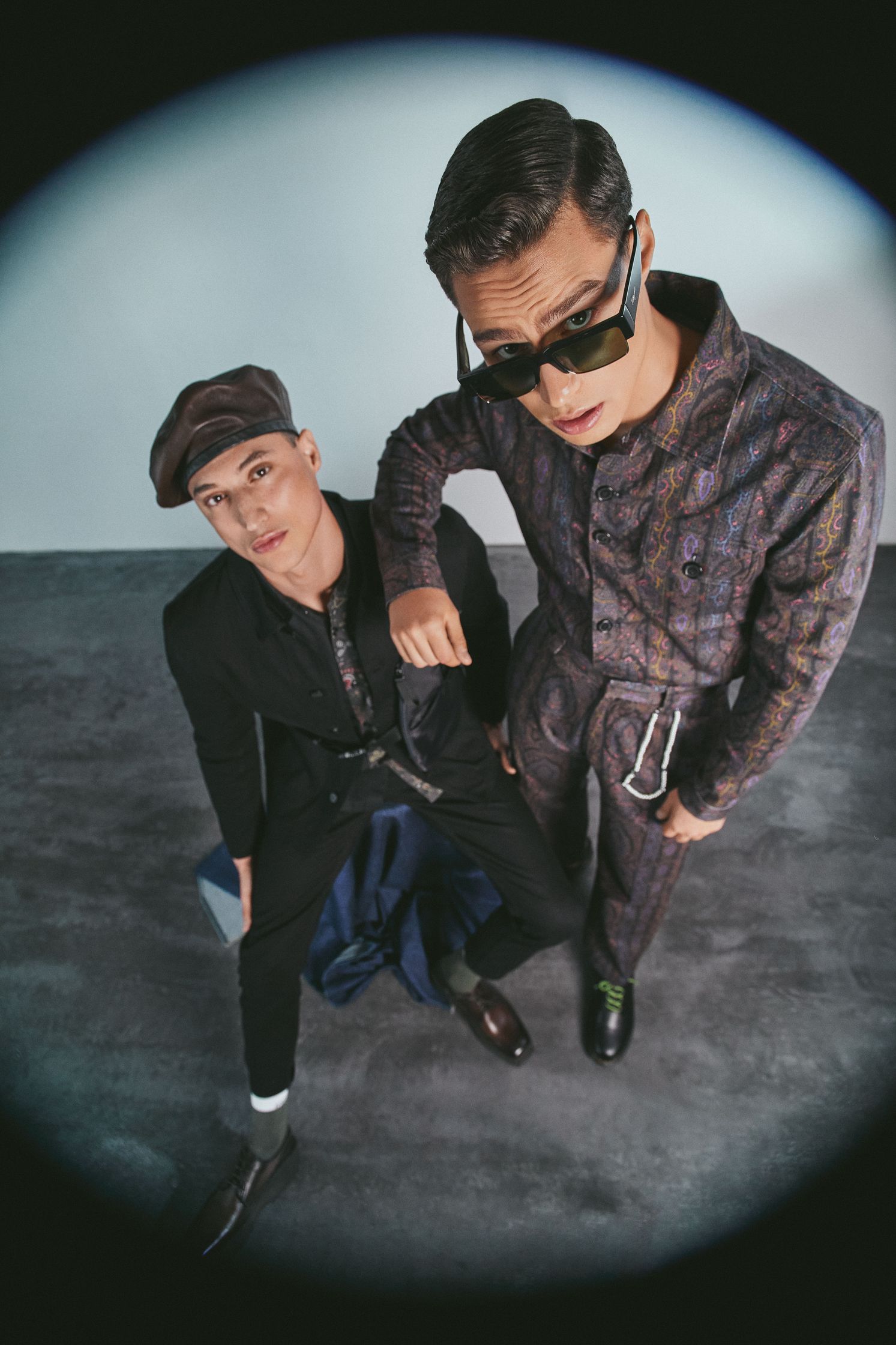two men in suits posing for a photo