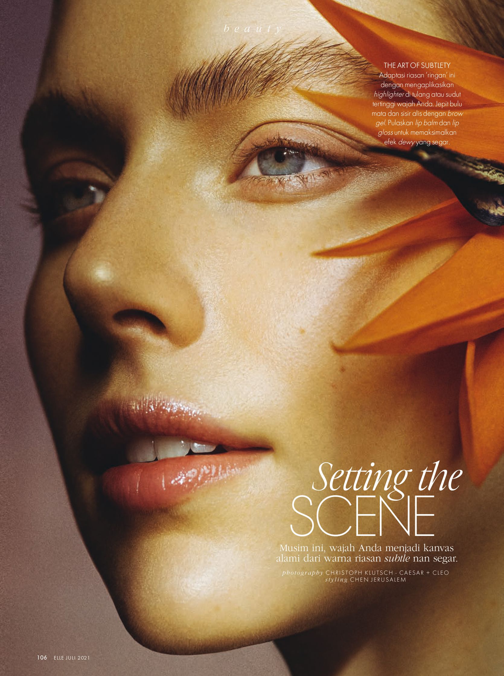 a woman with a flower on her face is featured in a magazine
