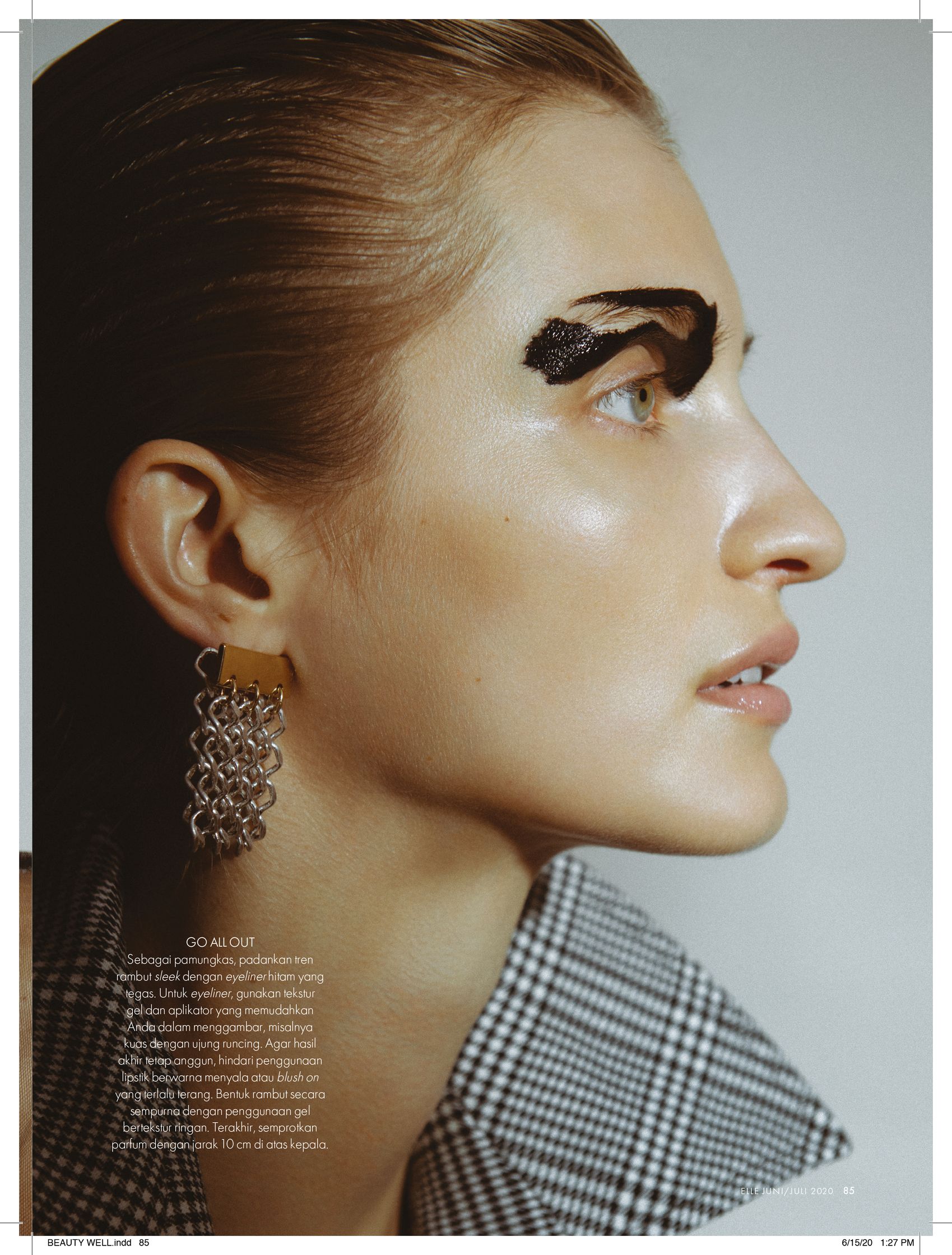 a woman in a plaid shirt with earrings on her face