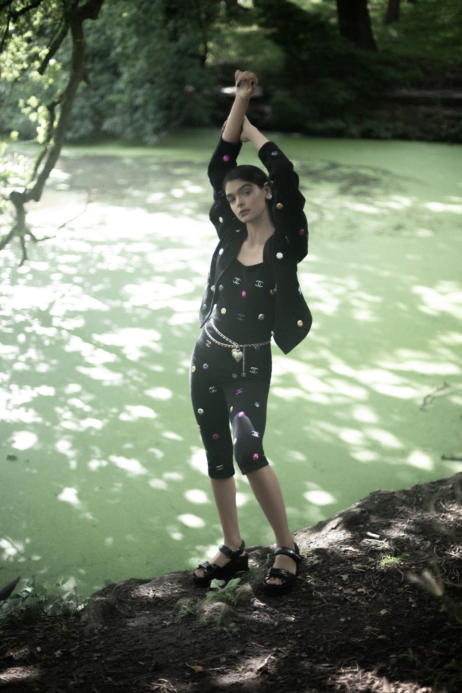 a woman standing on a green pond