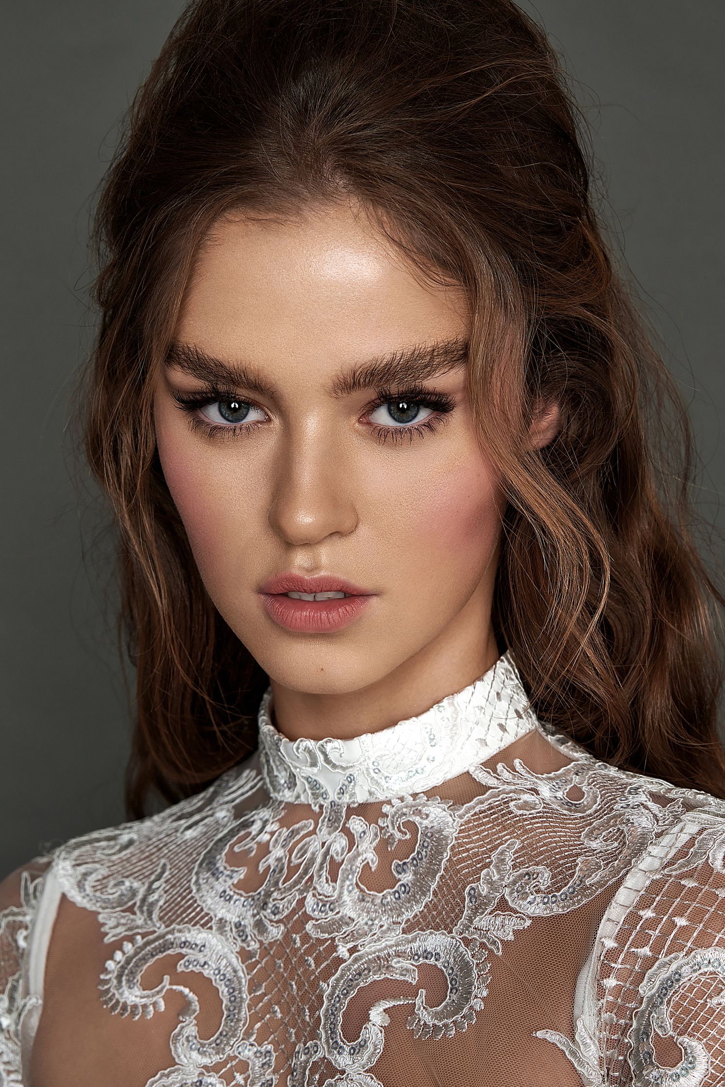 a model in a white lace dress with long hair