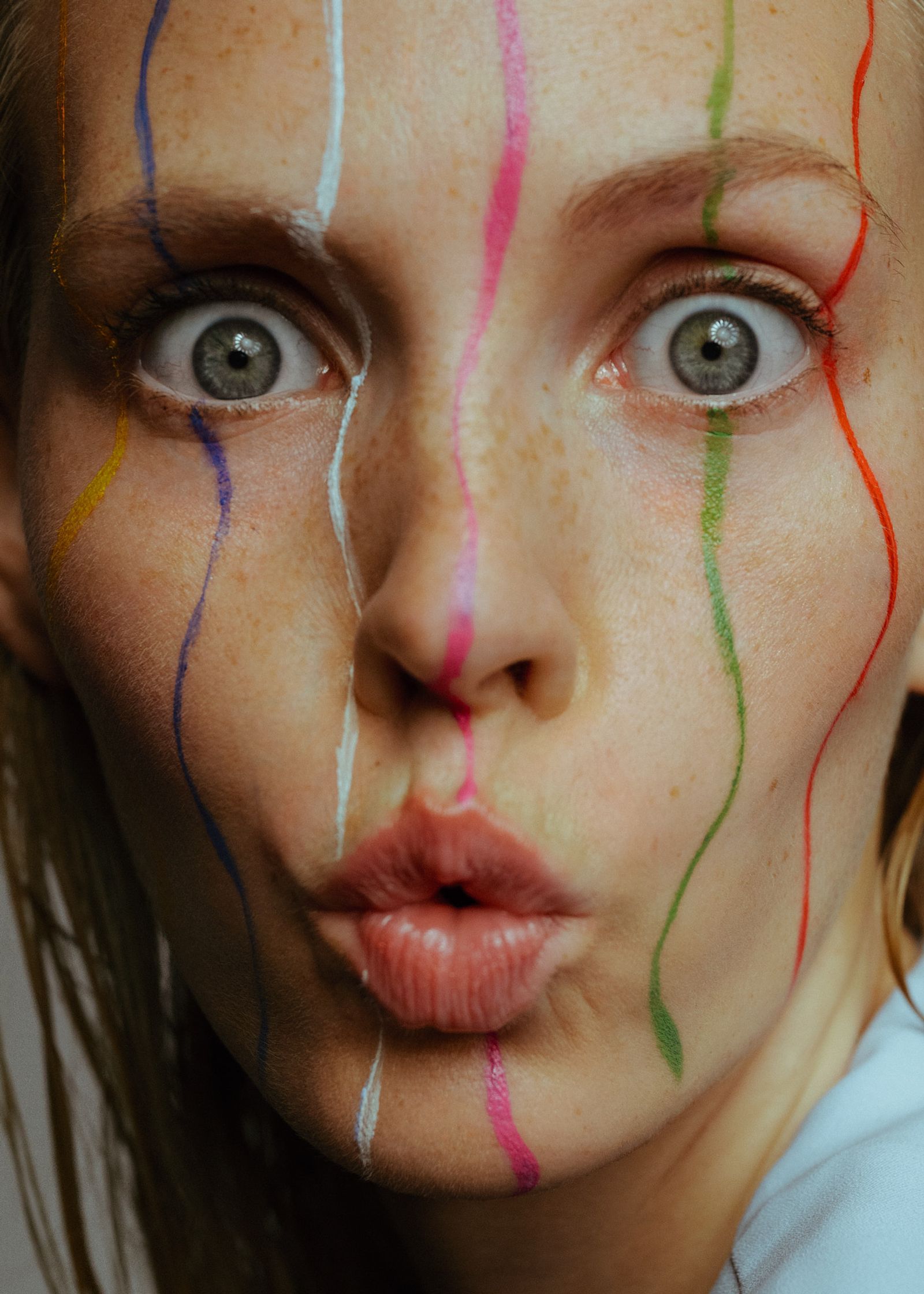 a woman with colorful paint on her face