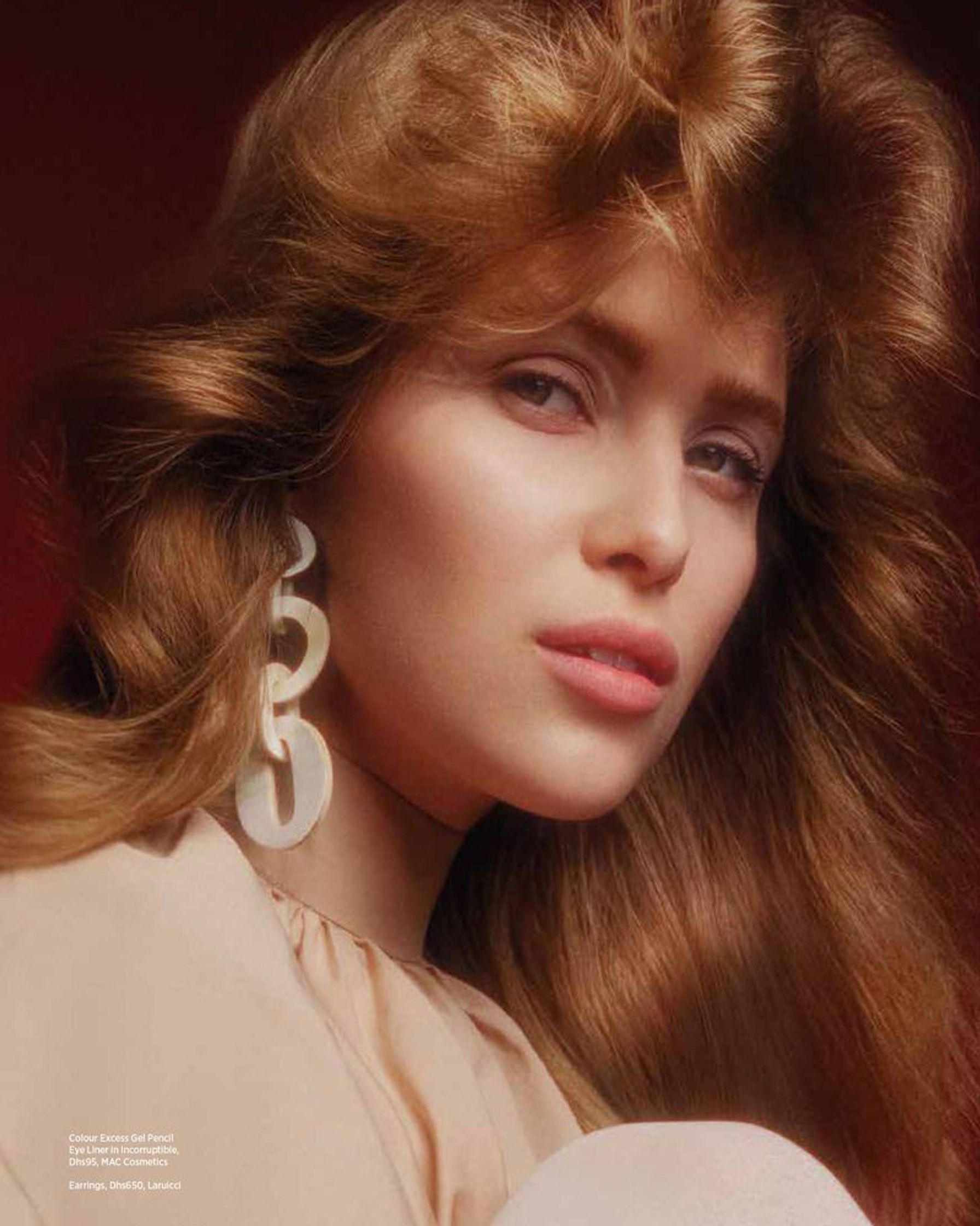 a woman with long hair posing for a magazine