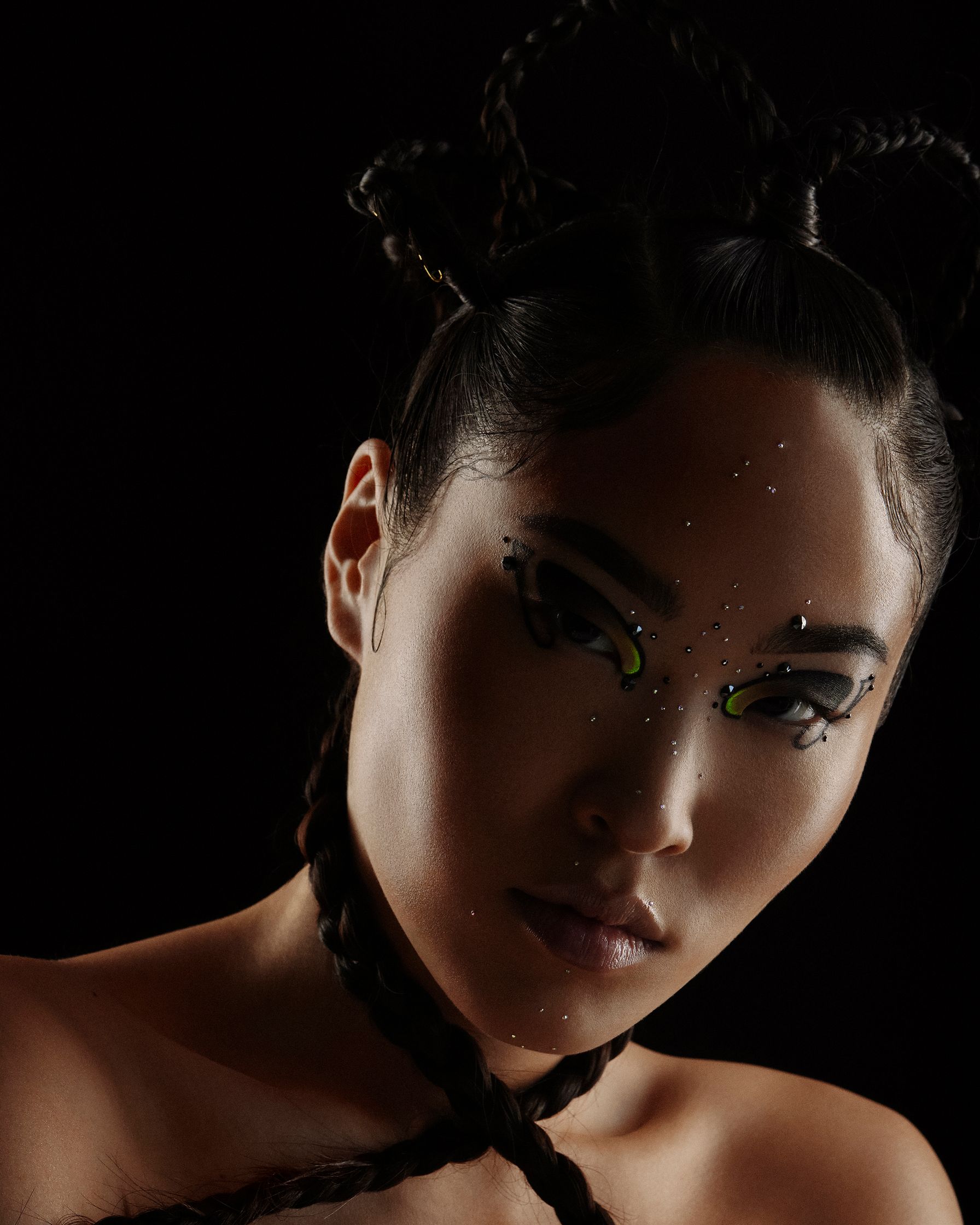 a woman with a braided headband and a black background