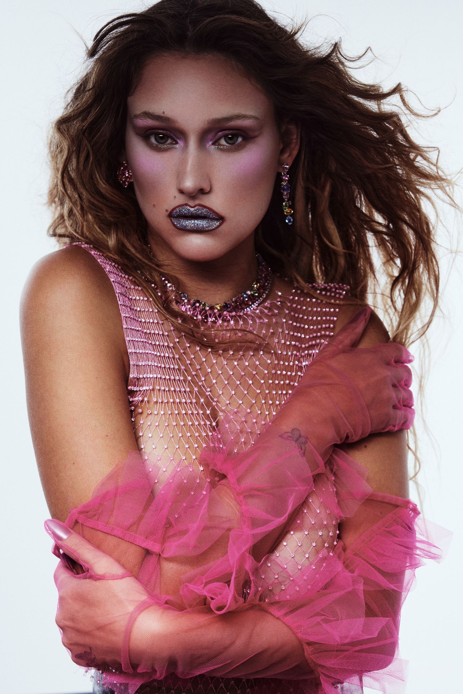 a woman in pink makeup posing for a photo