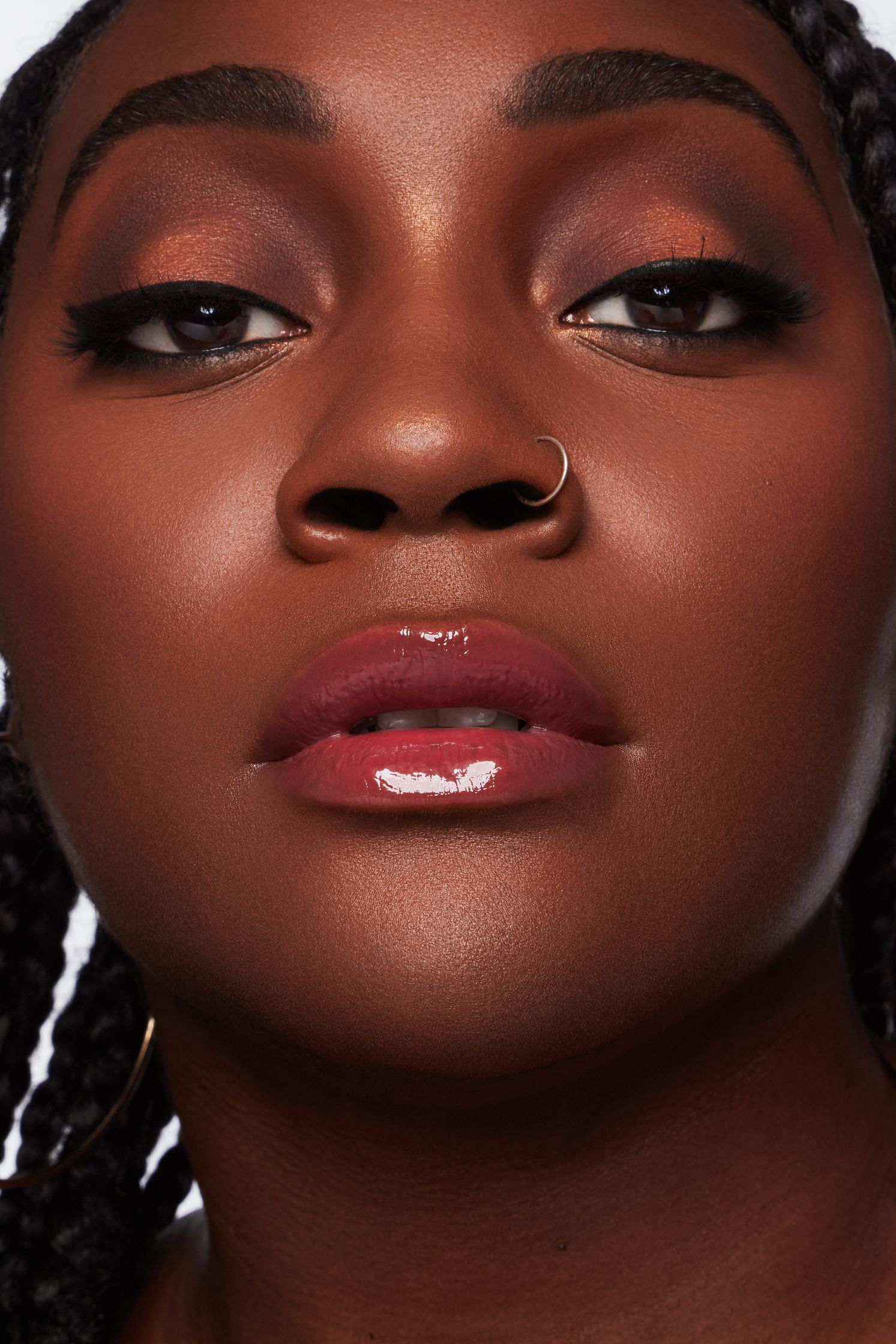 a black woman with braided hair and piercings