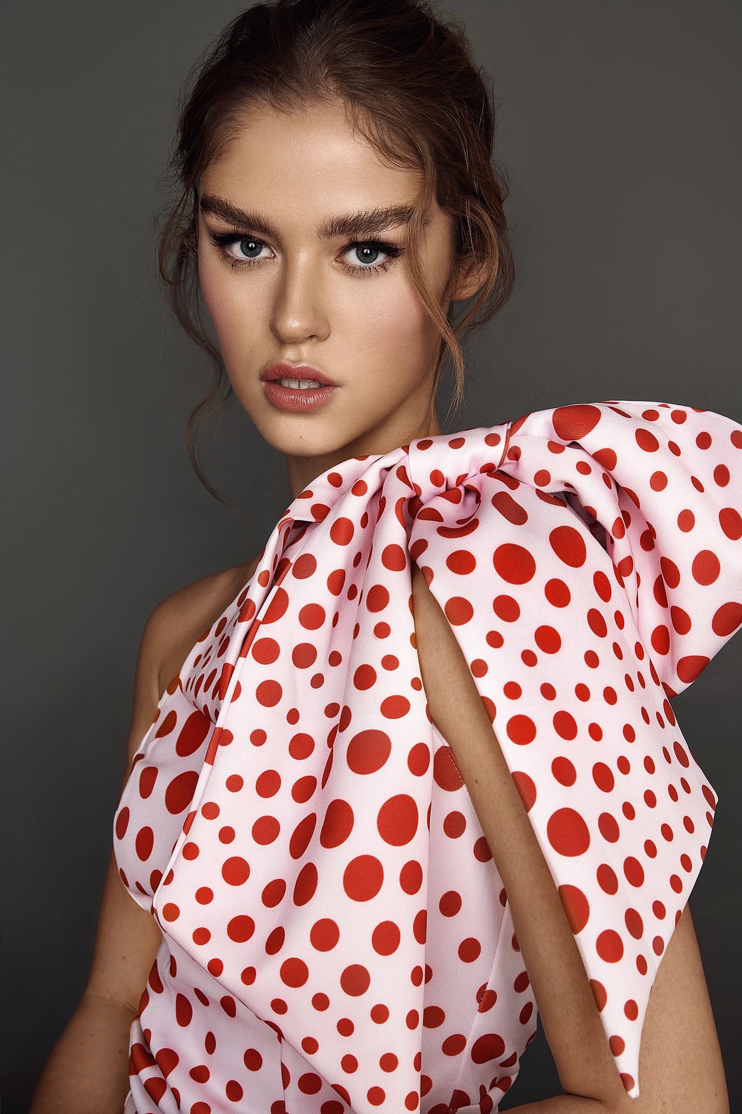 a model in a red and white polka dot dress