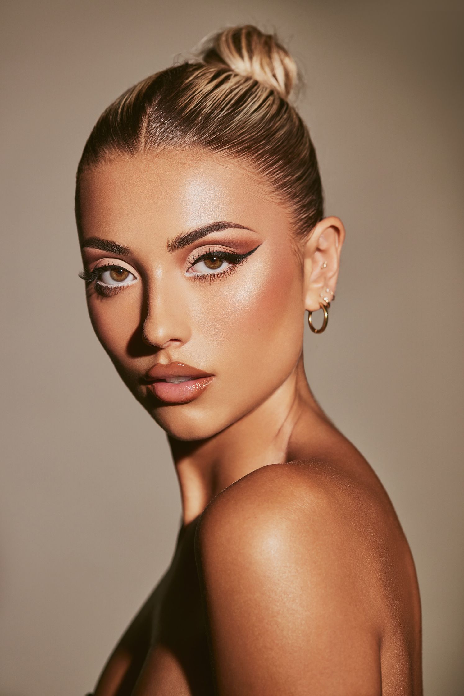 a blonde woman with makeup on her face