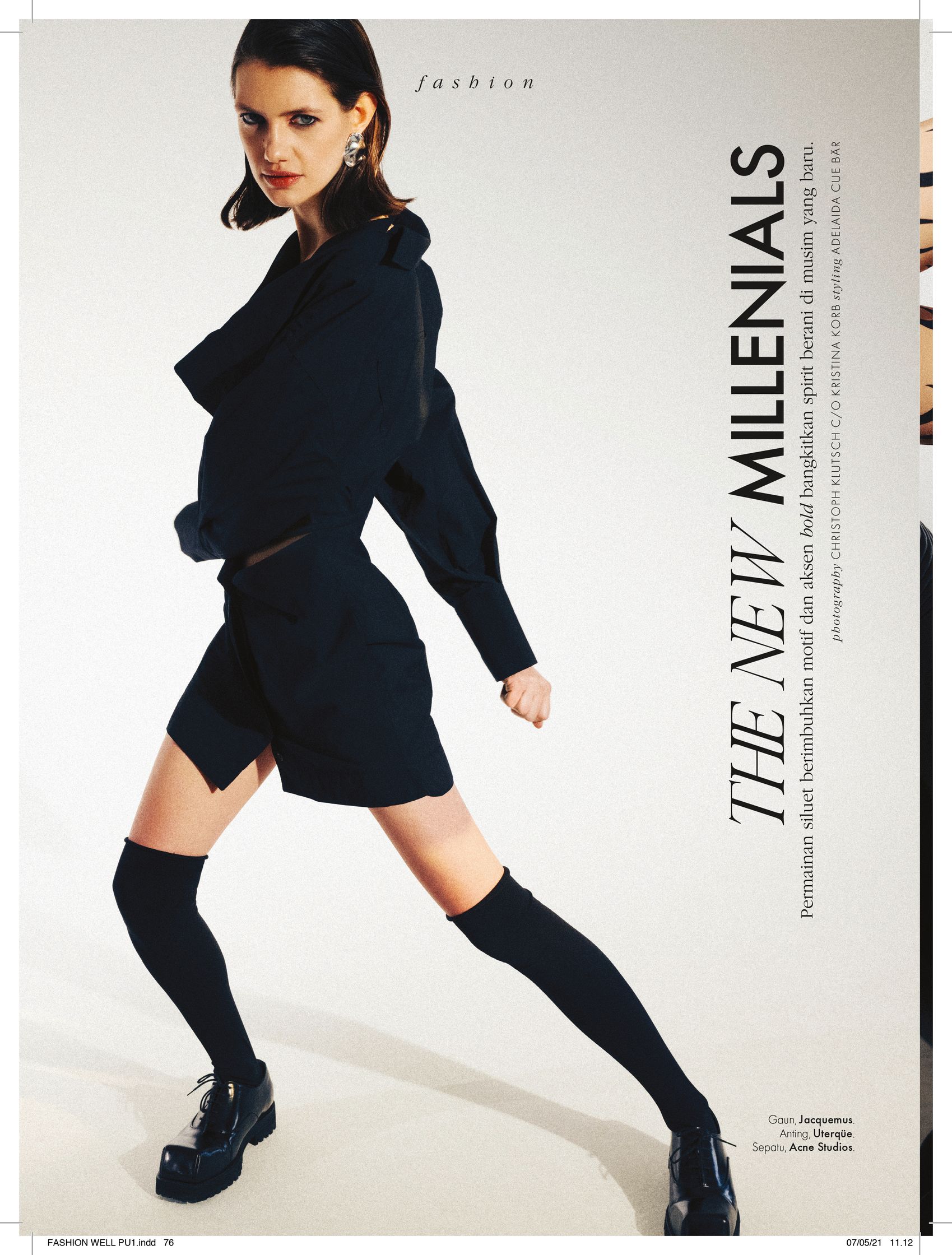 a woman in a black outfit is posing in a magazine