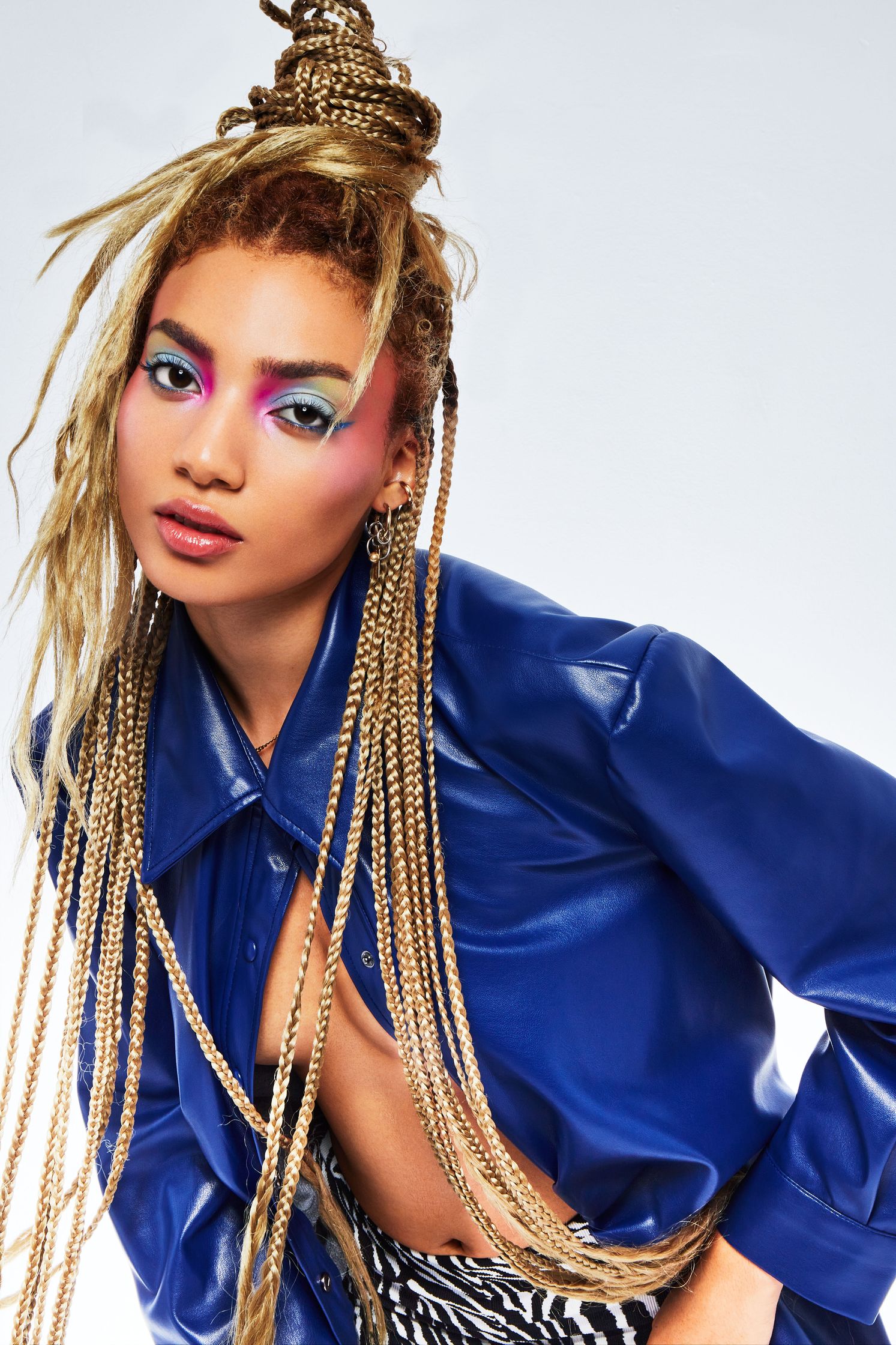 a woman in a blue jacket and zebra print pants