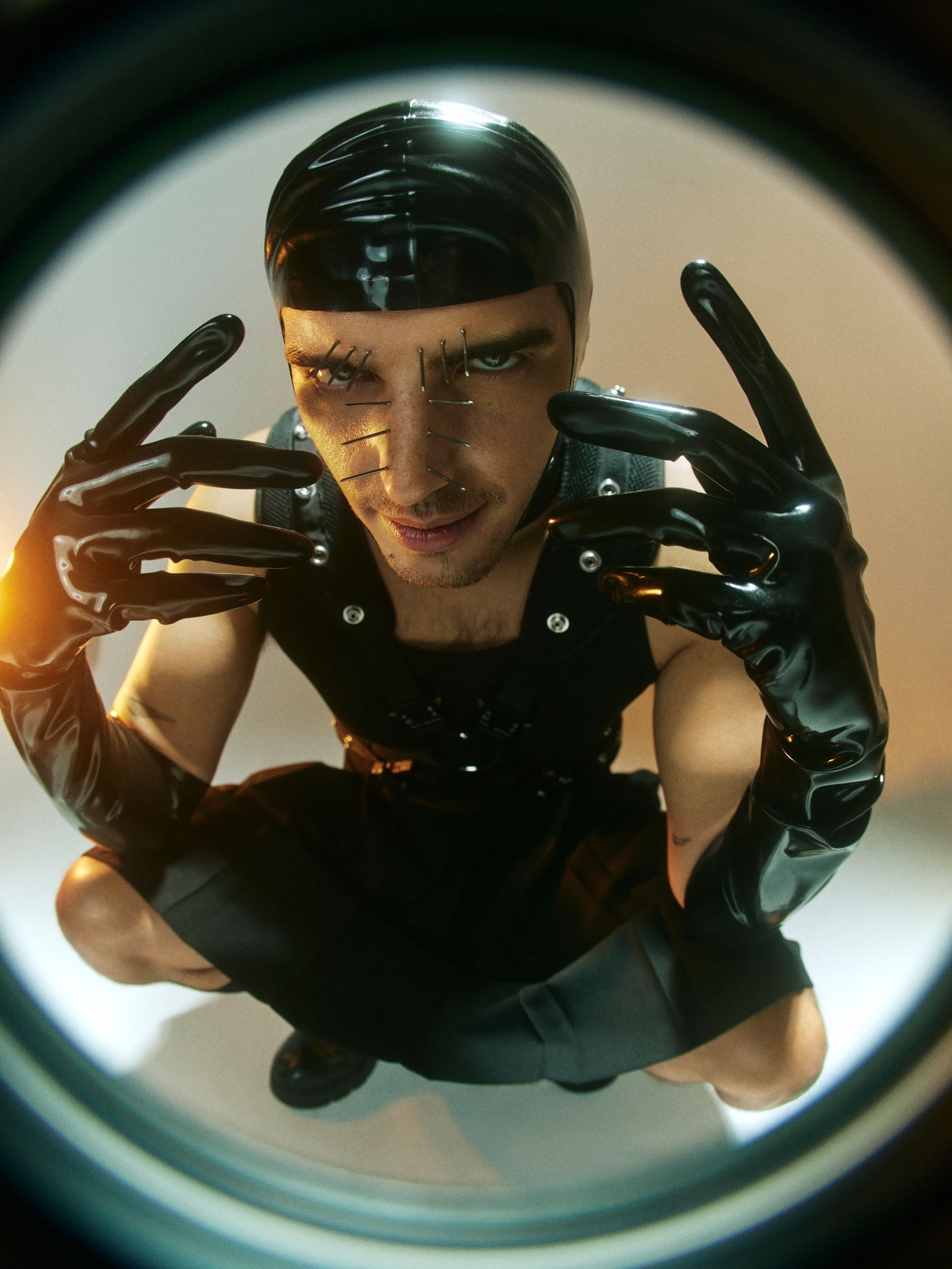 a man wearing latex gloves and a hat