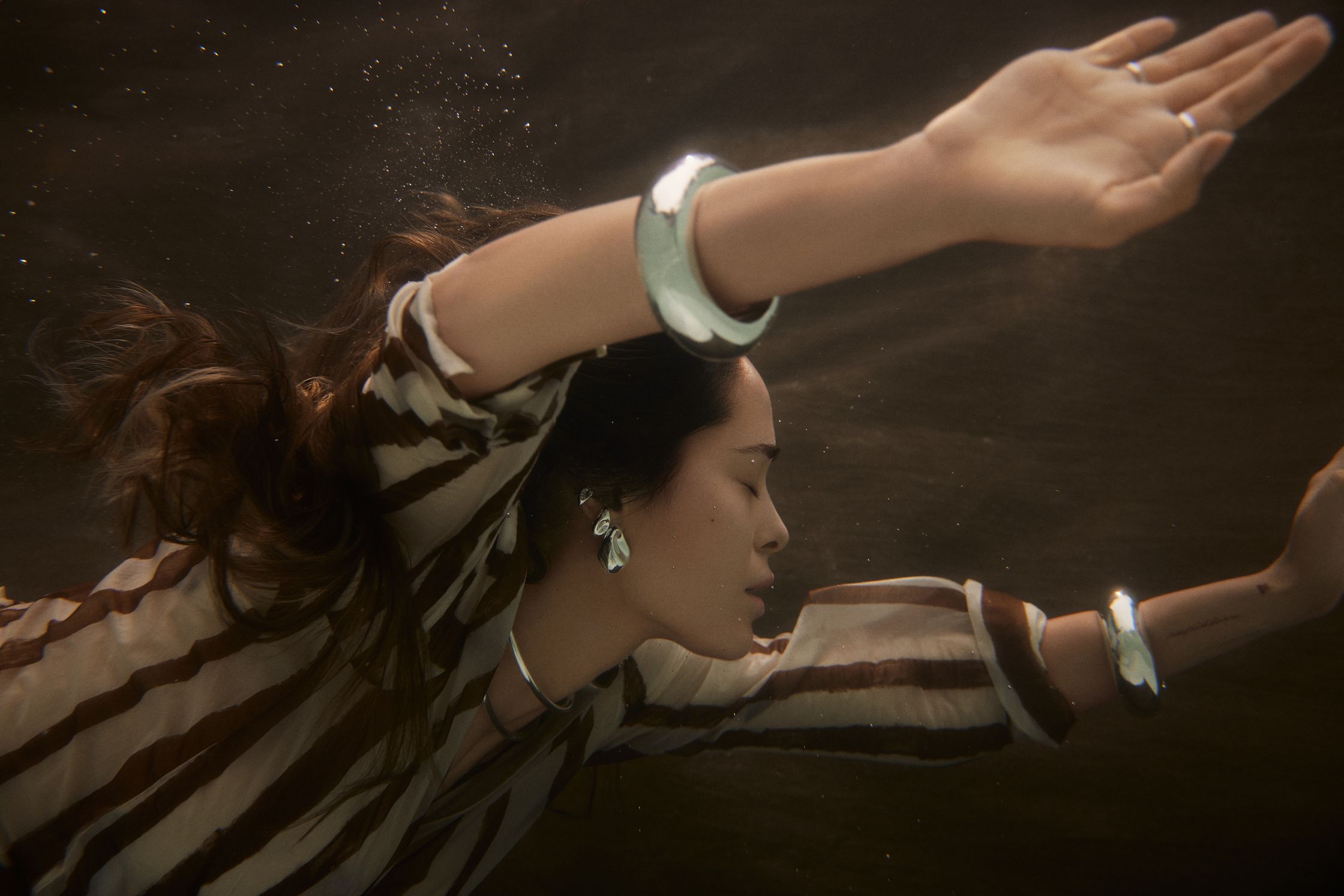 a woman underwater with her arms outstretched