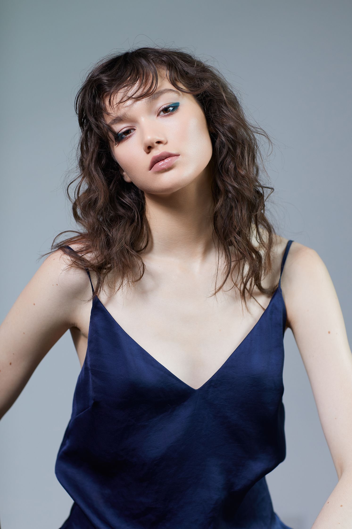 a woman in a blue dress posing for a photo
