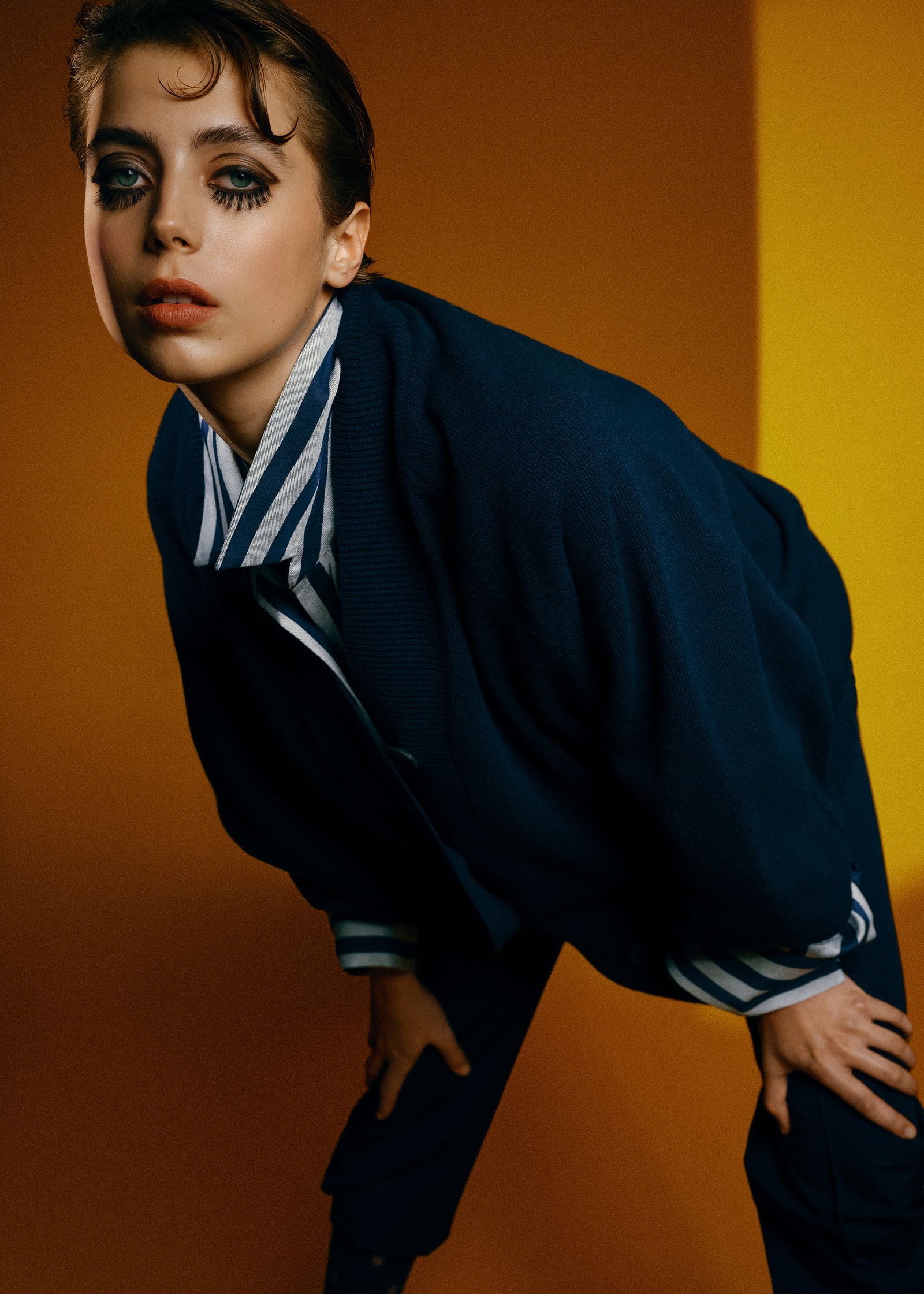 a woman in a blue jacket posing for a magazine
