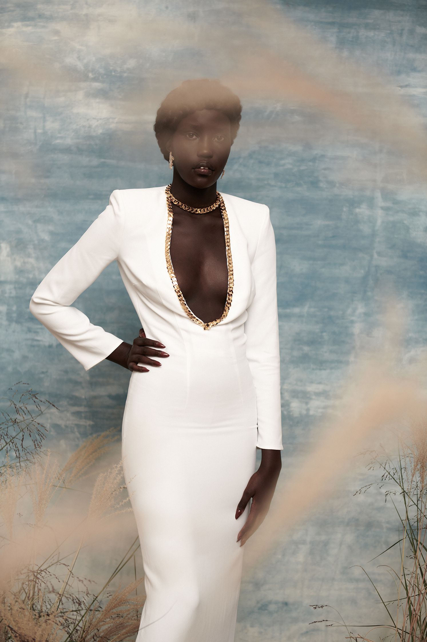 a woman in a white dress posing for a photo